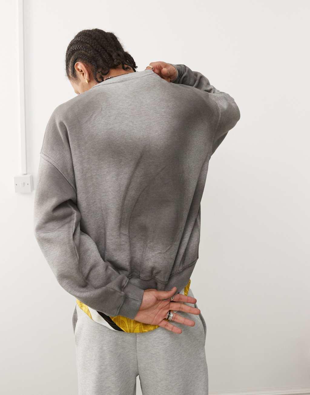 Weekday Liam oversized sweatshirt with faded graphic print and frayed seam details in spray wash gray Product Image