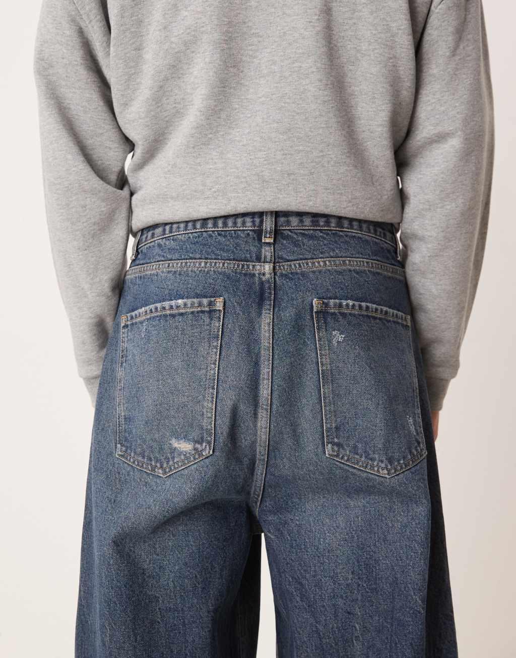 ASOS DESIGN skater fit jeans in dark wash blue with rips Product Image