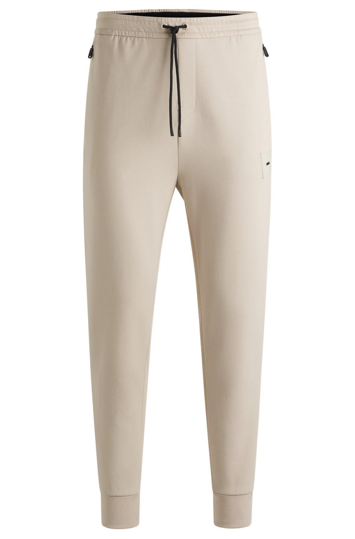 Stretch tracksuit bottoms with logo patch Product Image