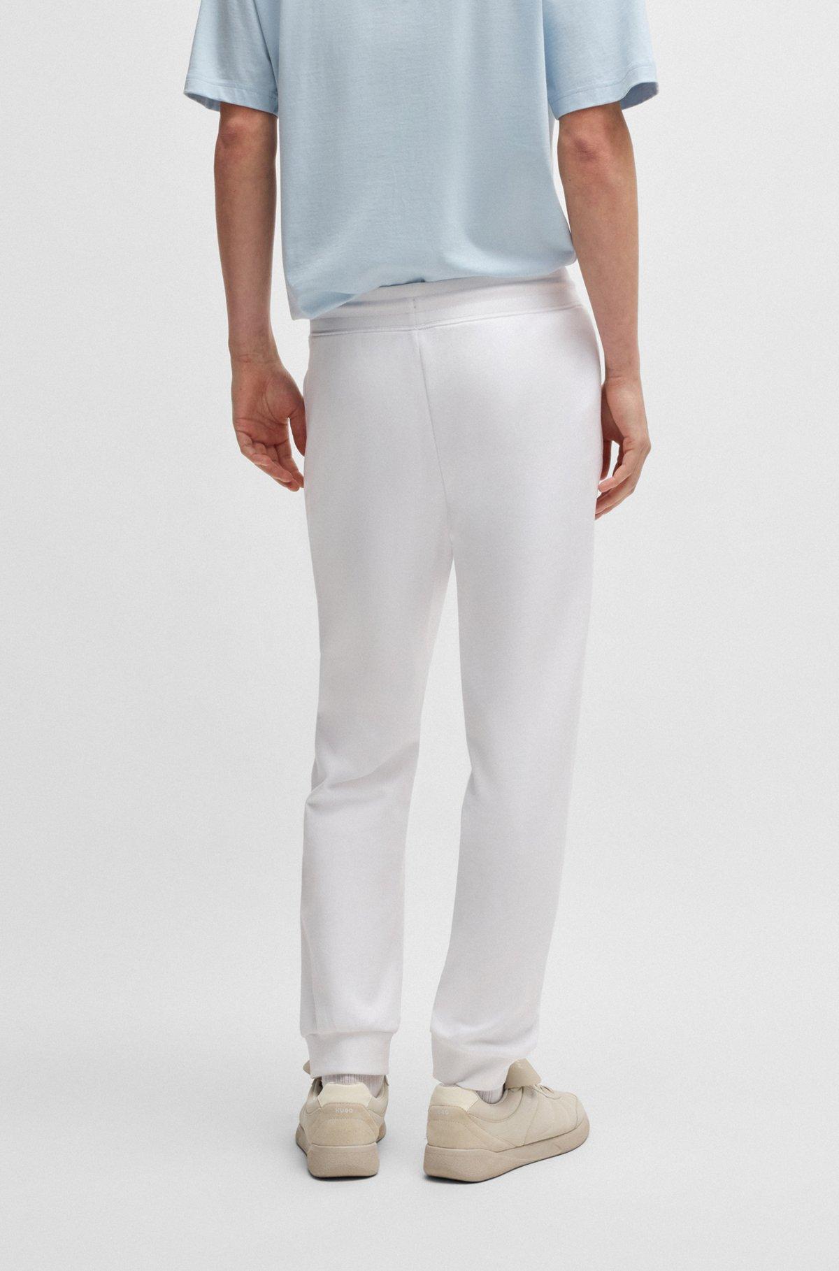 Cotton-terry tracksuit bottoms with Happy HUGO logo Product Image