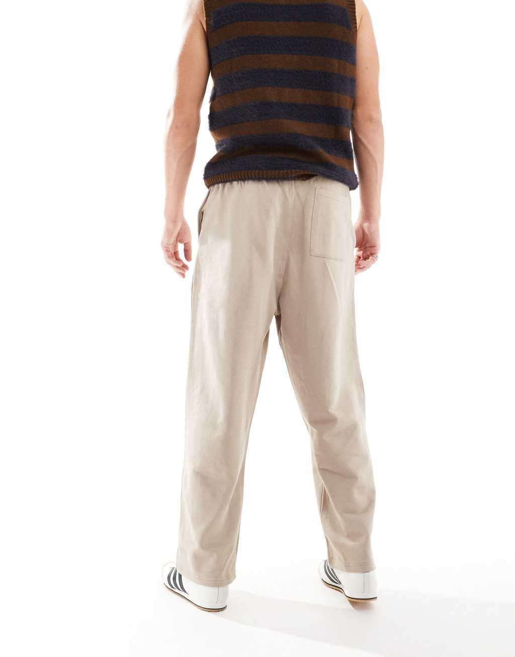 ASOS DESIGN wide leg pleated sweatpants in beige Product Image