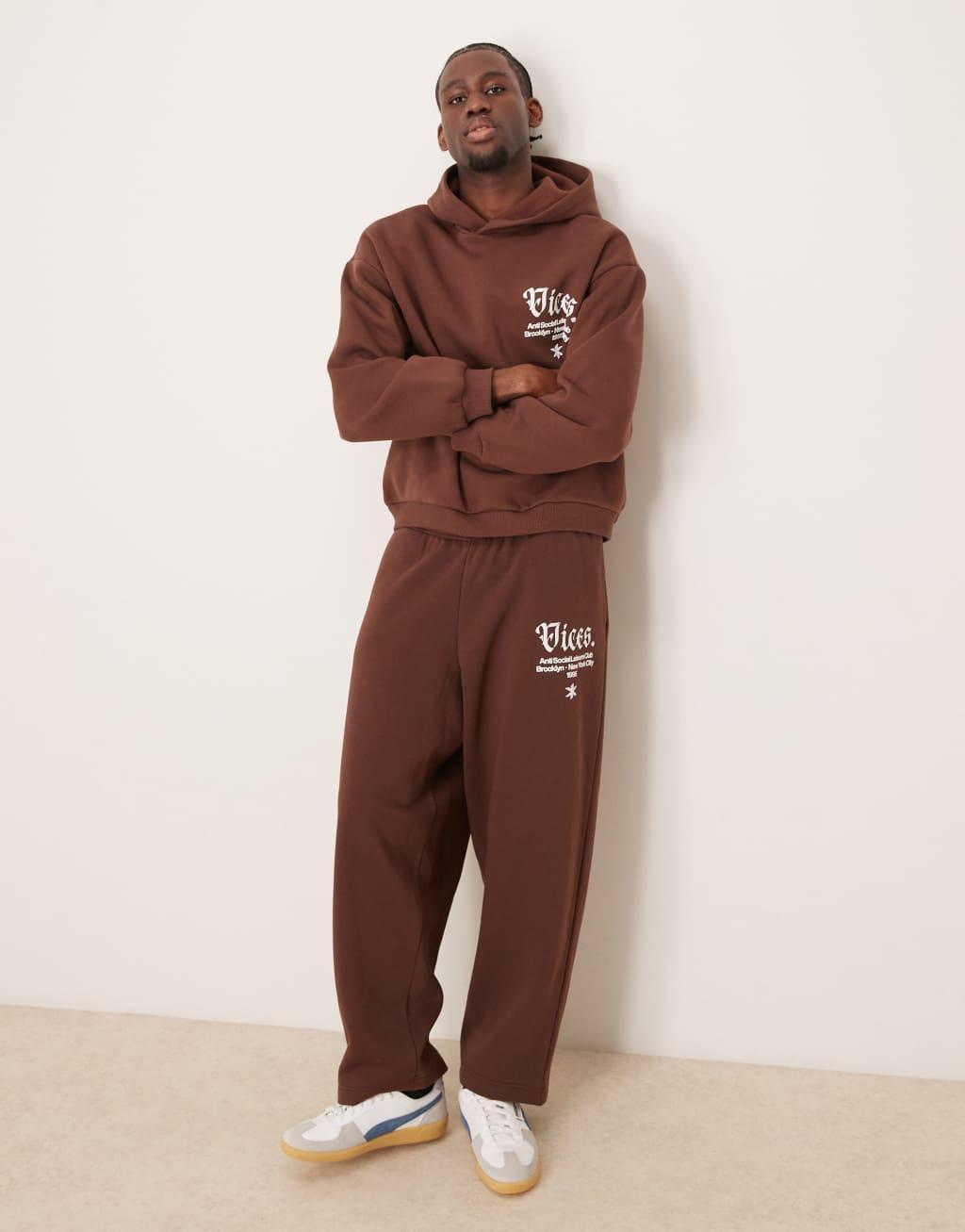 ASOS DESIGN baggy balloon sweatpants with print in brown Product Image