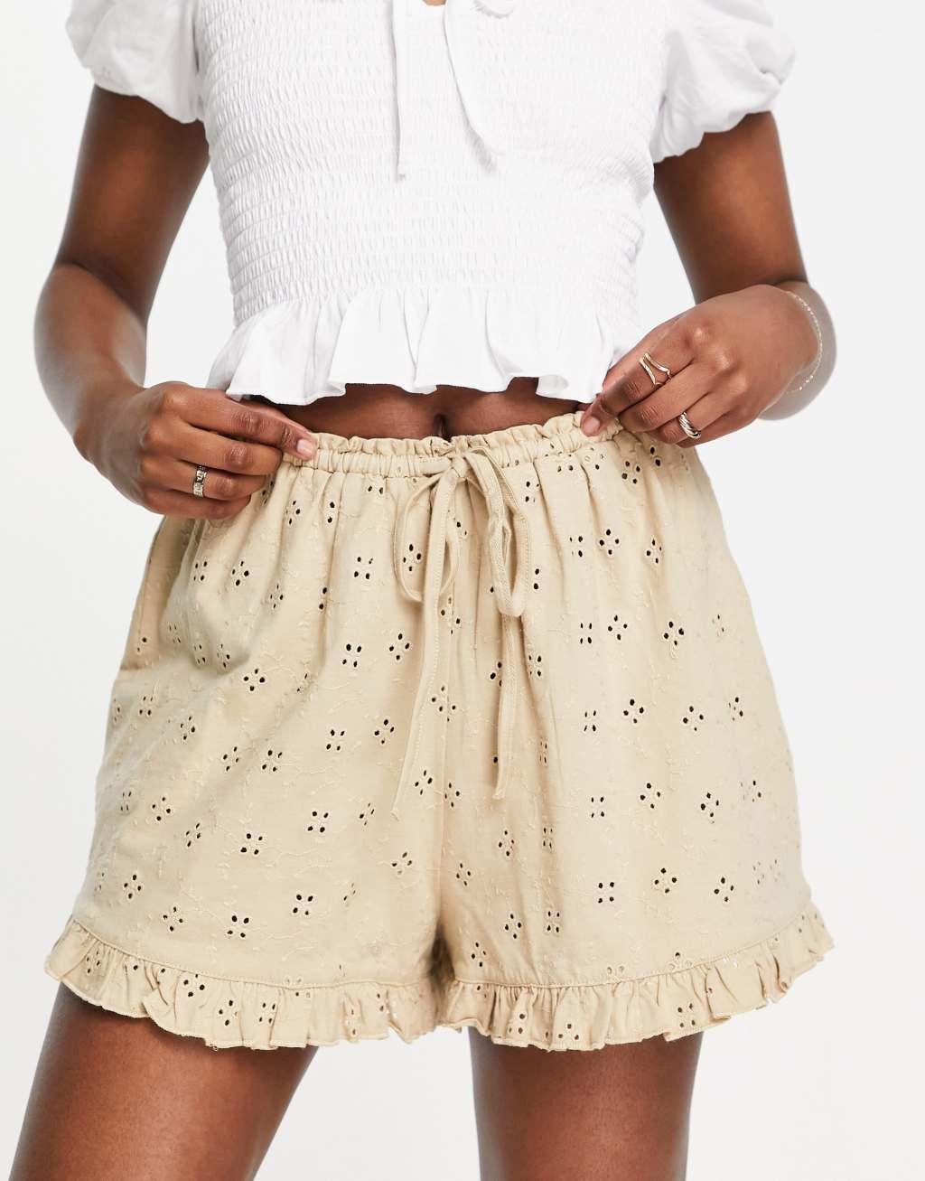 ASOS DESIGN broderie shorts with ruffle hem and tie waist in neutral Product Image