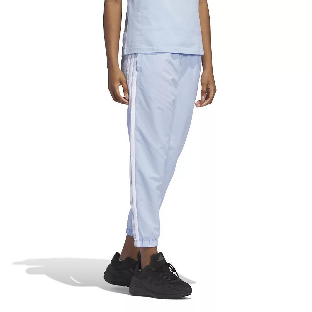 Women's adidas Essentials 3-Stripes Woven 7/8 Sportswear Pants, Size: Medium, Glow Blue Product Image