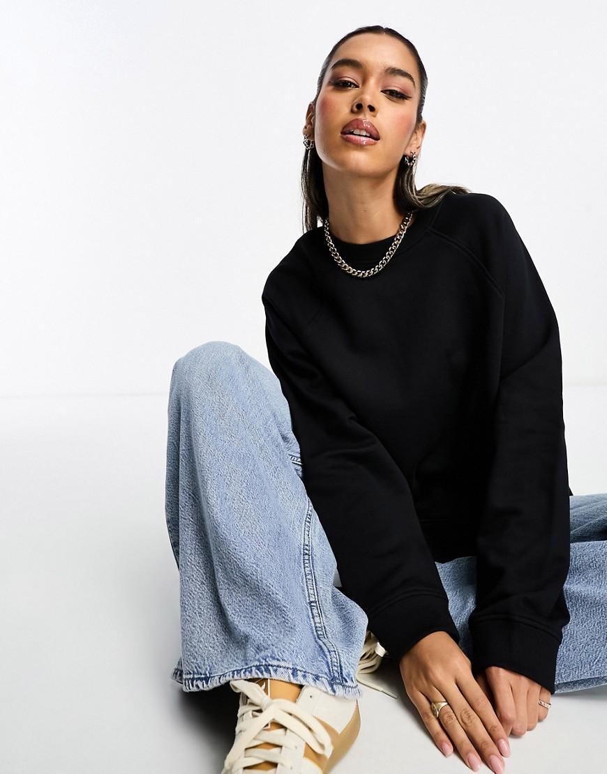 ASOS DESIGN oversized sweat with raglan detail in black Product Image