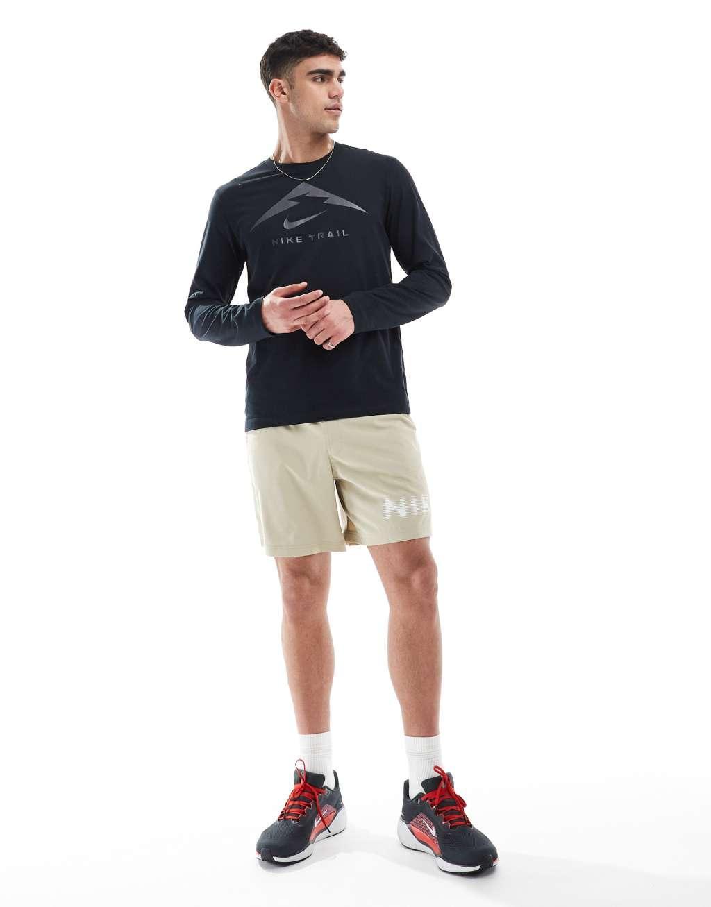 Nike Training blurred swoosh graphic 7 inch shorts in beige Product Image