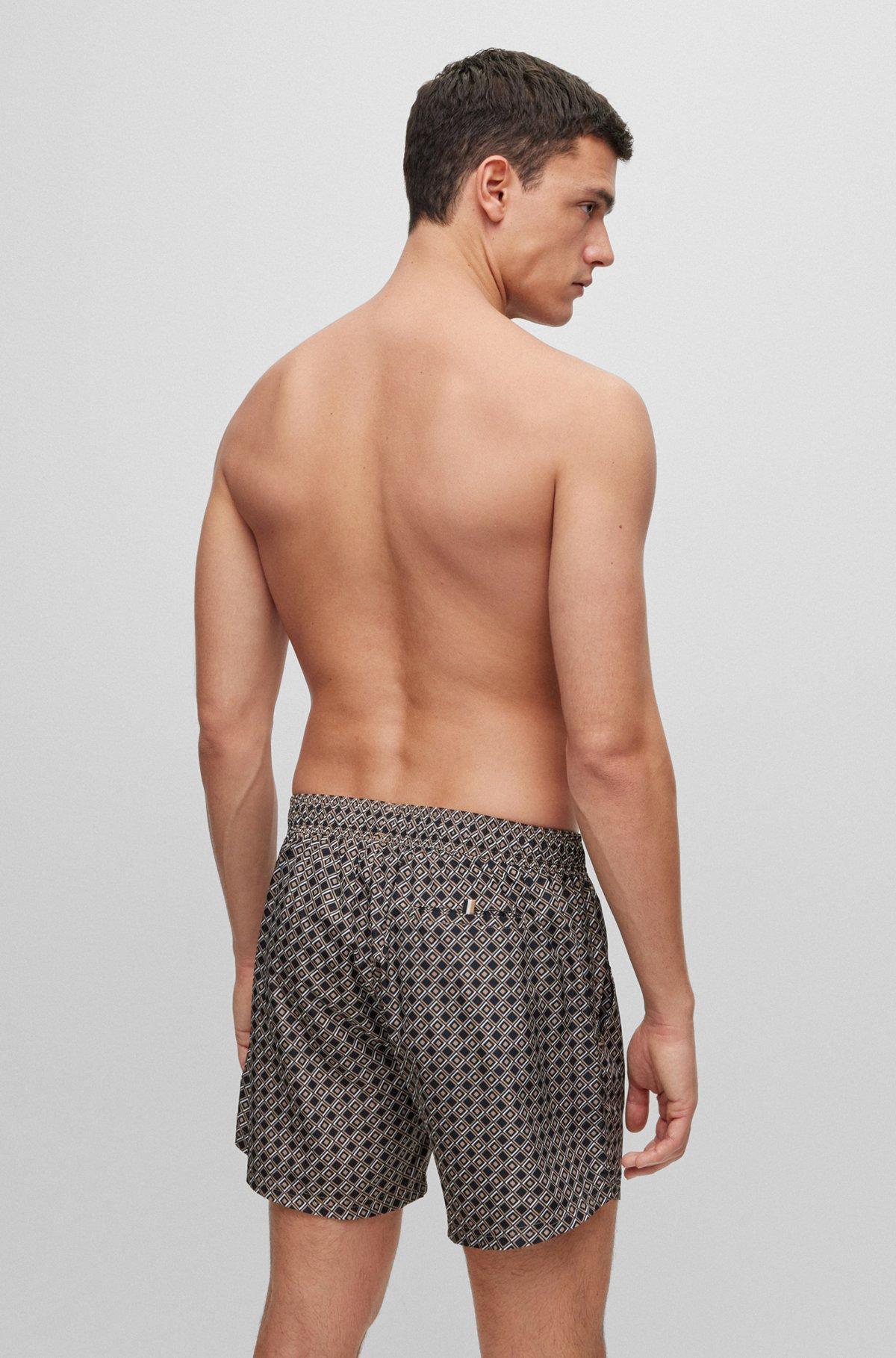 Logo swim shorts with all-over seasonal pattern Product Image