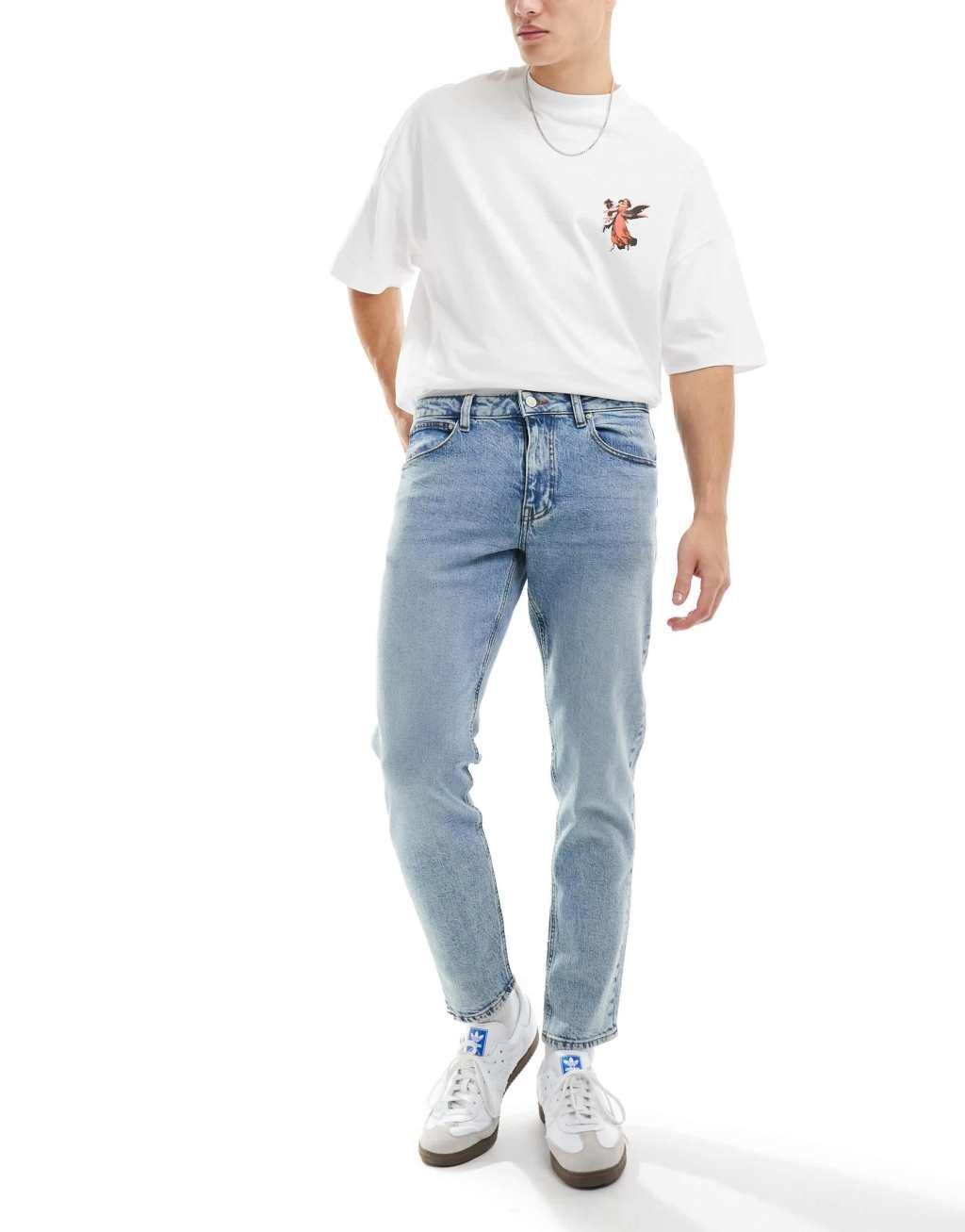 ASOS DESIGN stretch tapered jeans in light wash blue Product Image