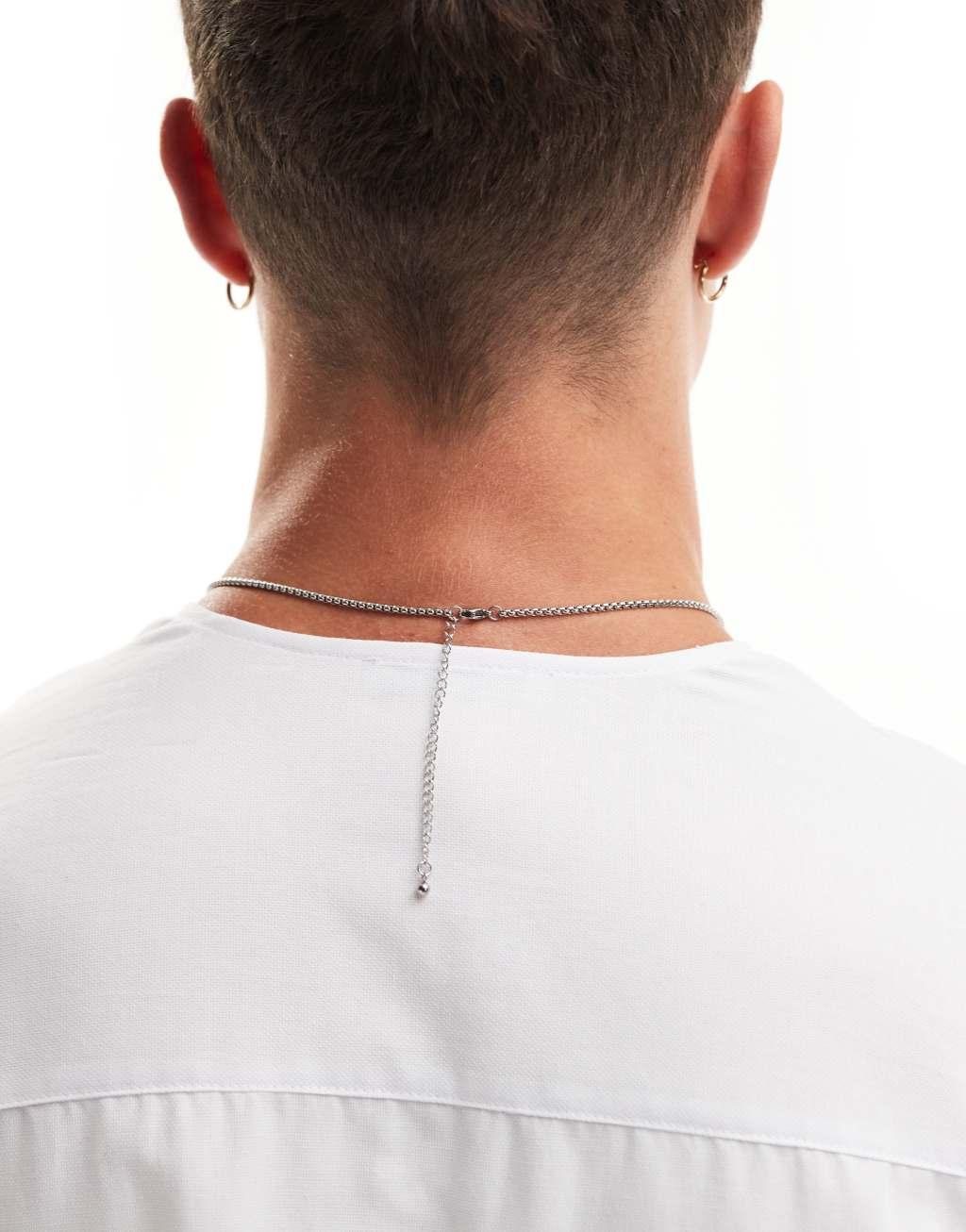 ASOS DESIGN waterproof stainless steel necklace with brushed metal cross tag pendant in silver tone Product Image