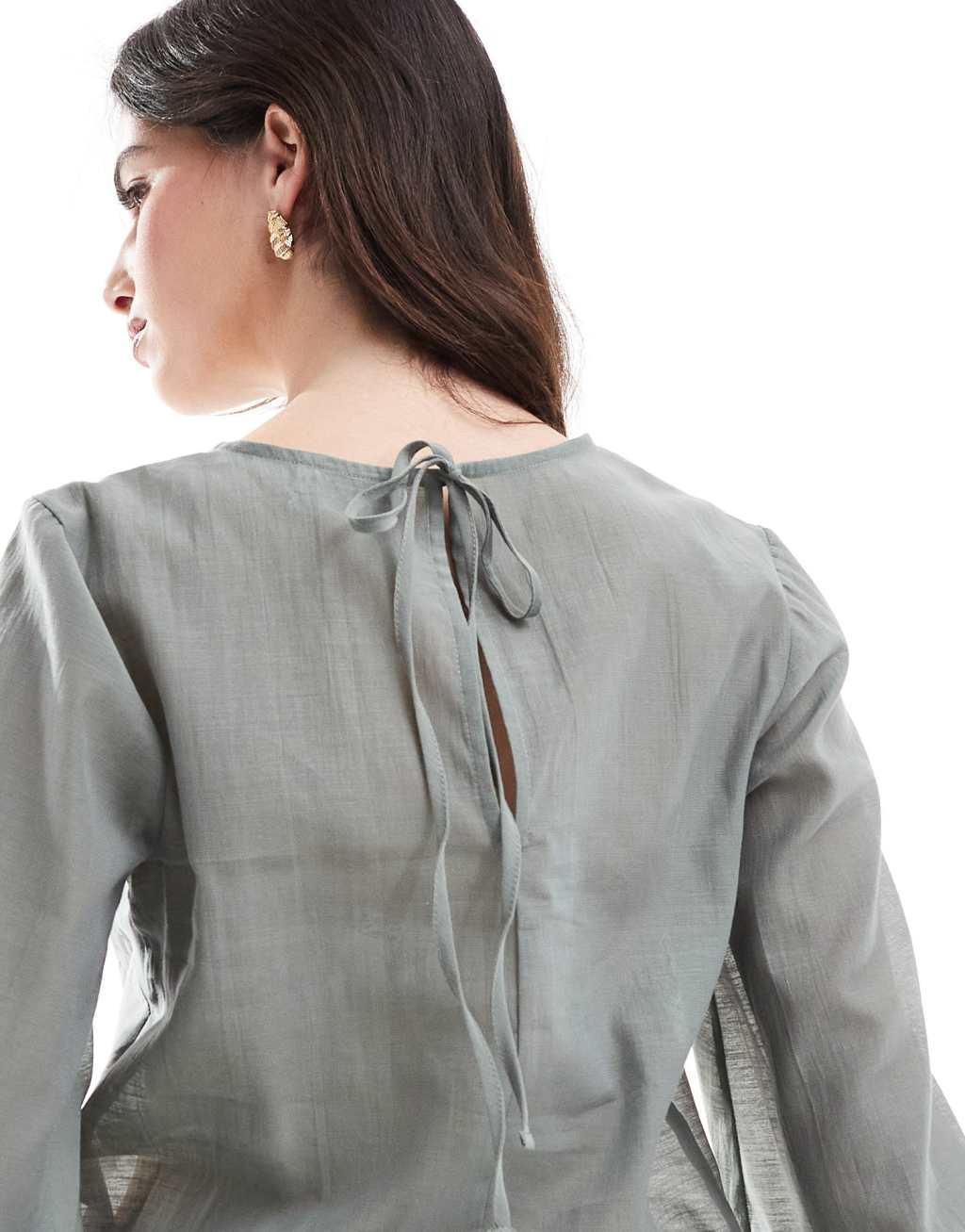 ASOS DESIGN long sleeve peplum hem top in green Product Image
