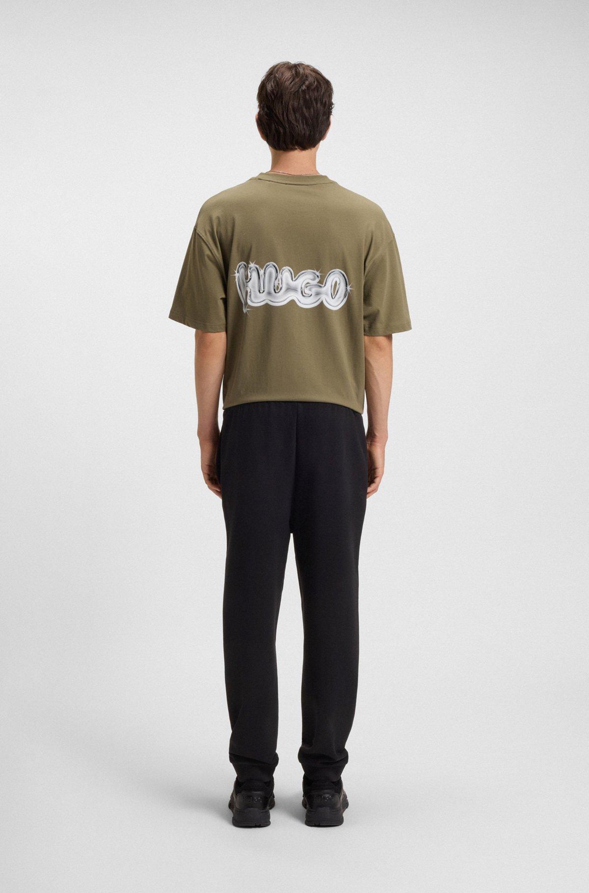 Cotton-terry tracksuit bottoms with Happy HUGO logo Product Image