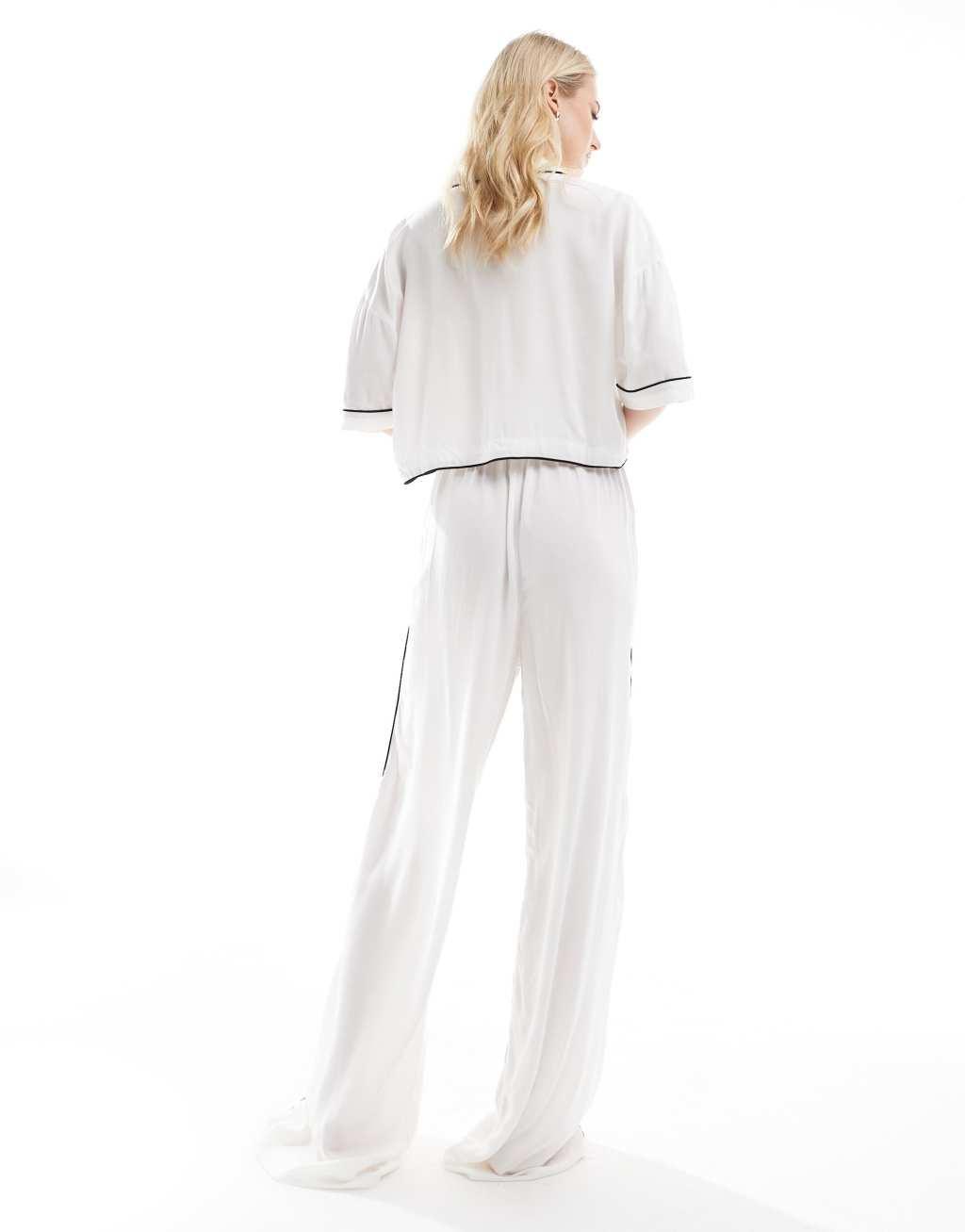 ASOS DESIGN Tall super soft slinky wide leg pajama pants in white with contrast binding Product Image