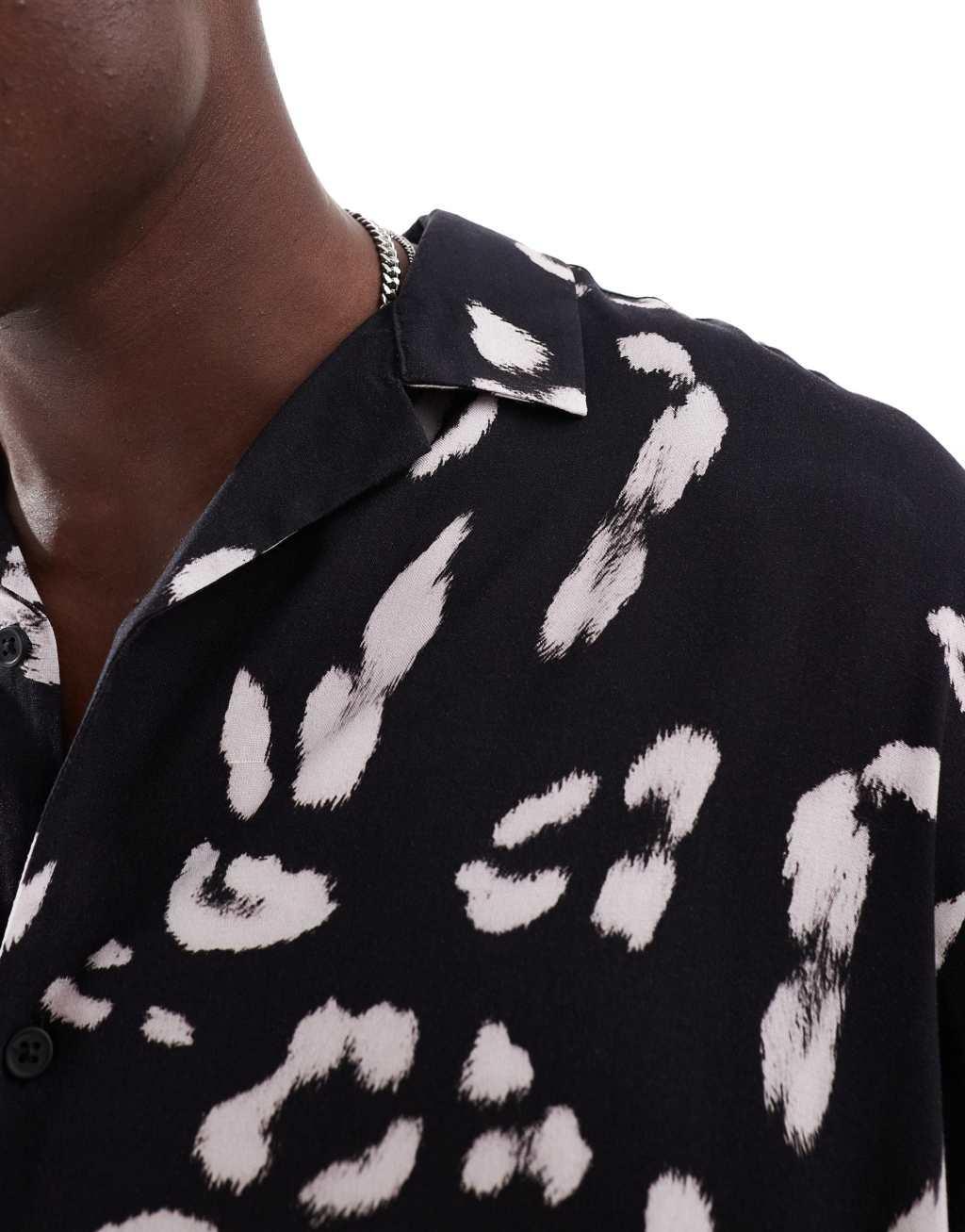 ASOS DESIGN oversized revere shirt with leopard print in black Product Image