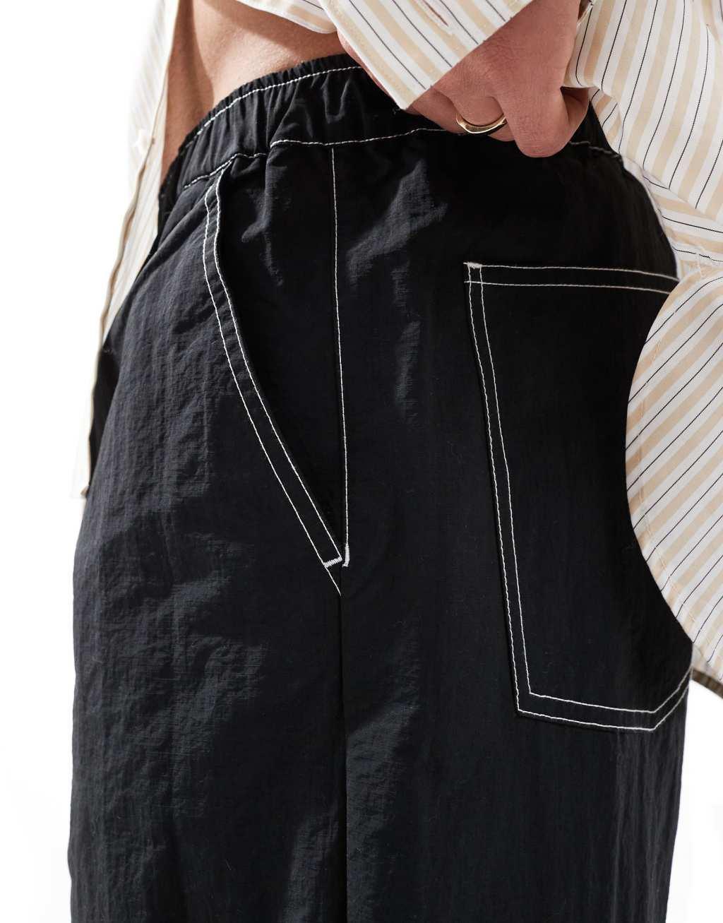 ASOS DESIGN baggy pants in black nylon with contrast stitch Product Image