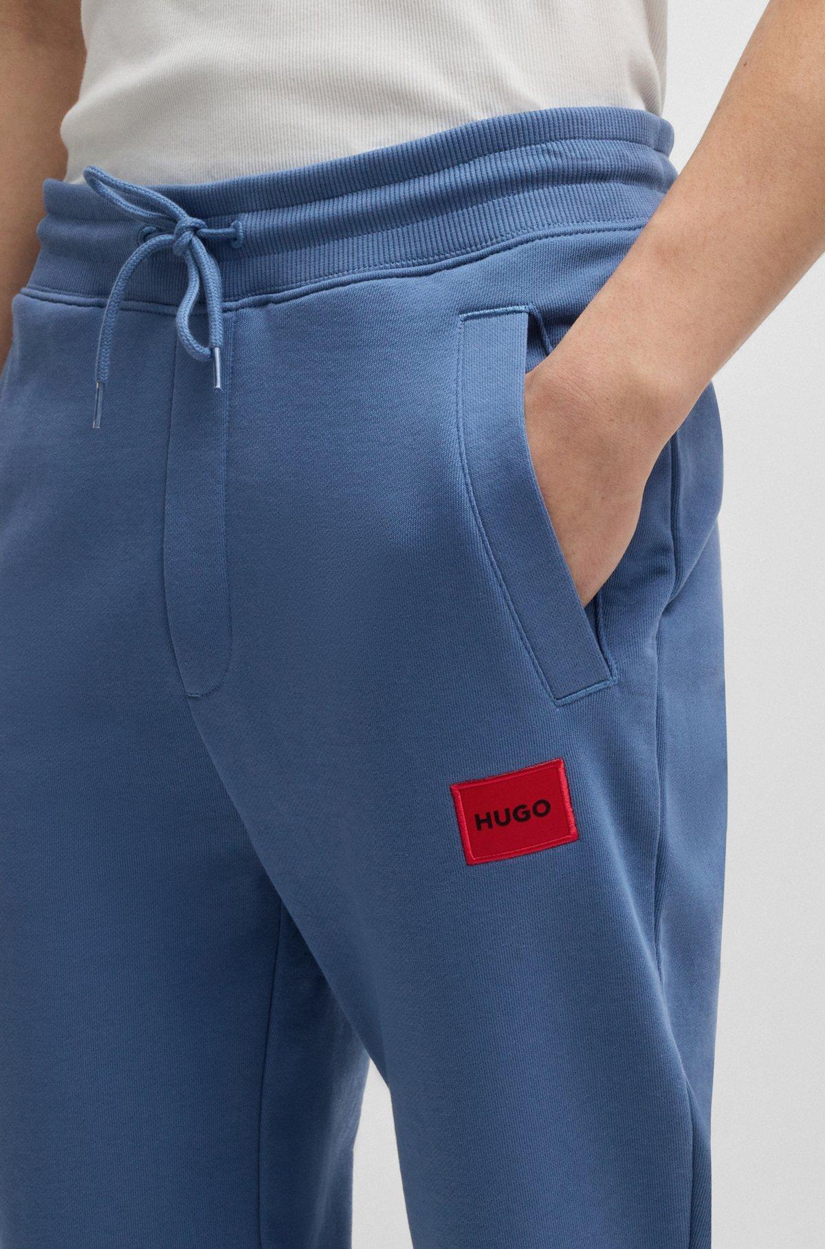 Cotton-terry tracksuit bottoms with logo label Product Image