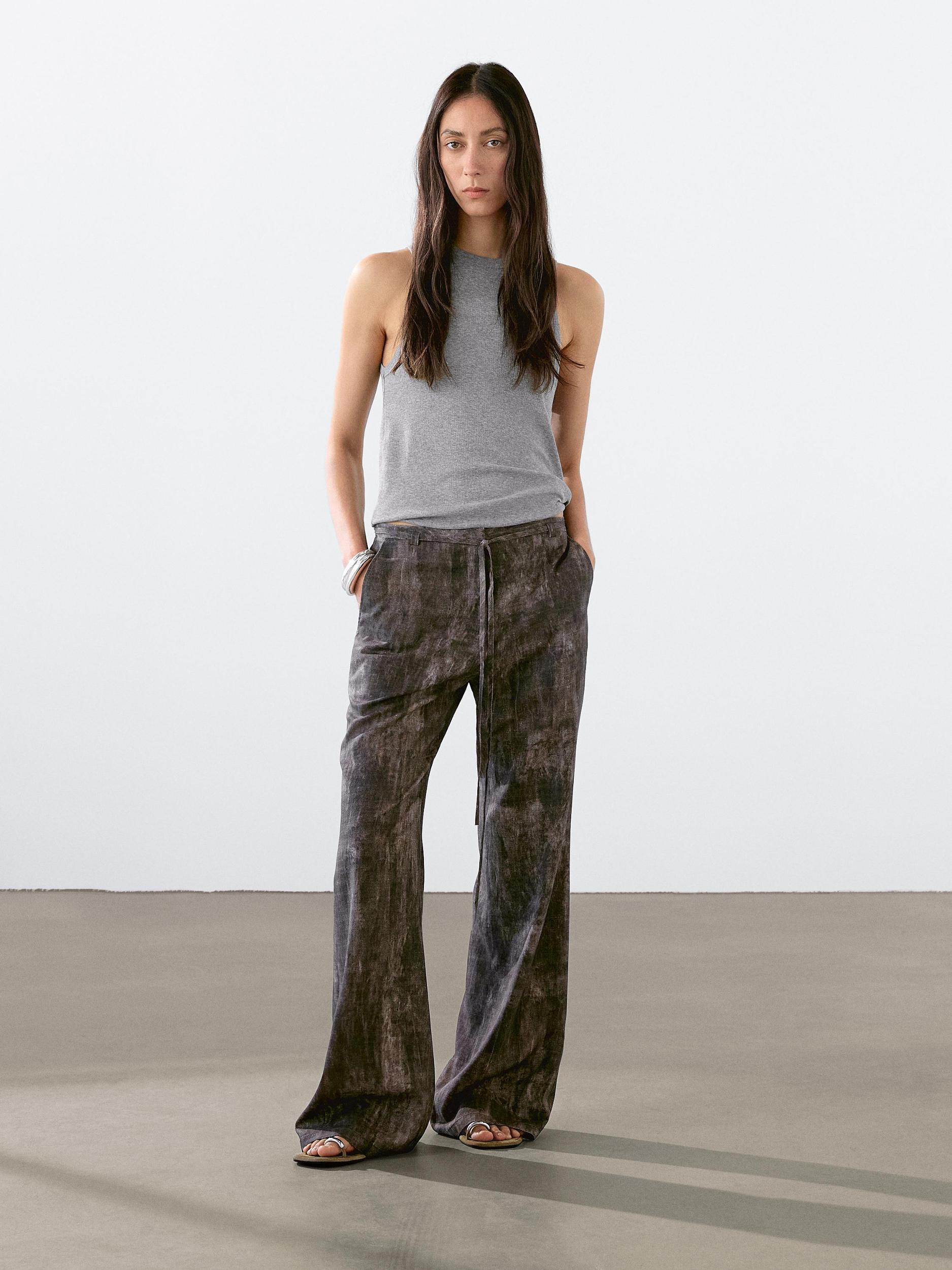 Distressed-effect flared trousers Product Image