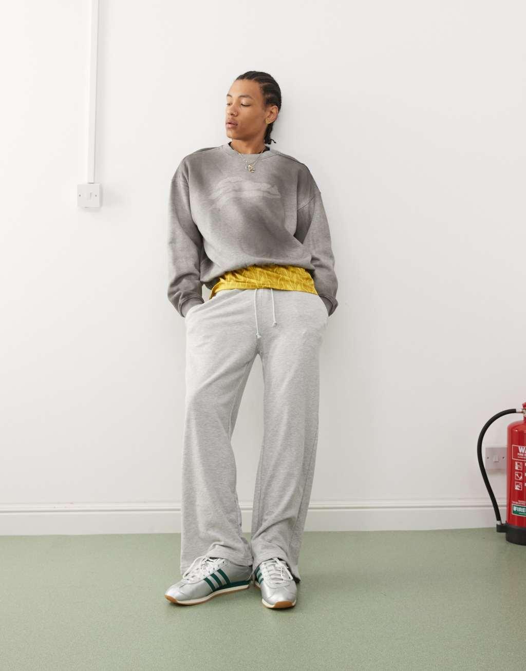 Weekday Liam oversized sweatshirt with faded graphic print and frayed seam details in spray wash gray Product Image