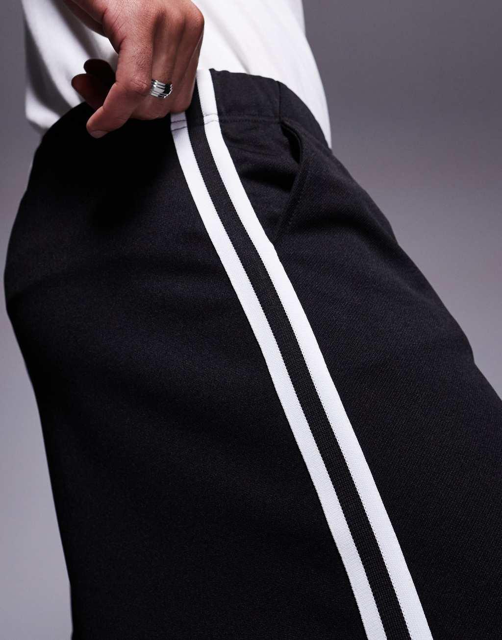 ASOS DESIGN baggy balloon sweatpants with side tape in black Product Image