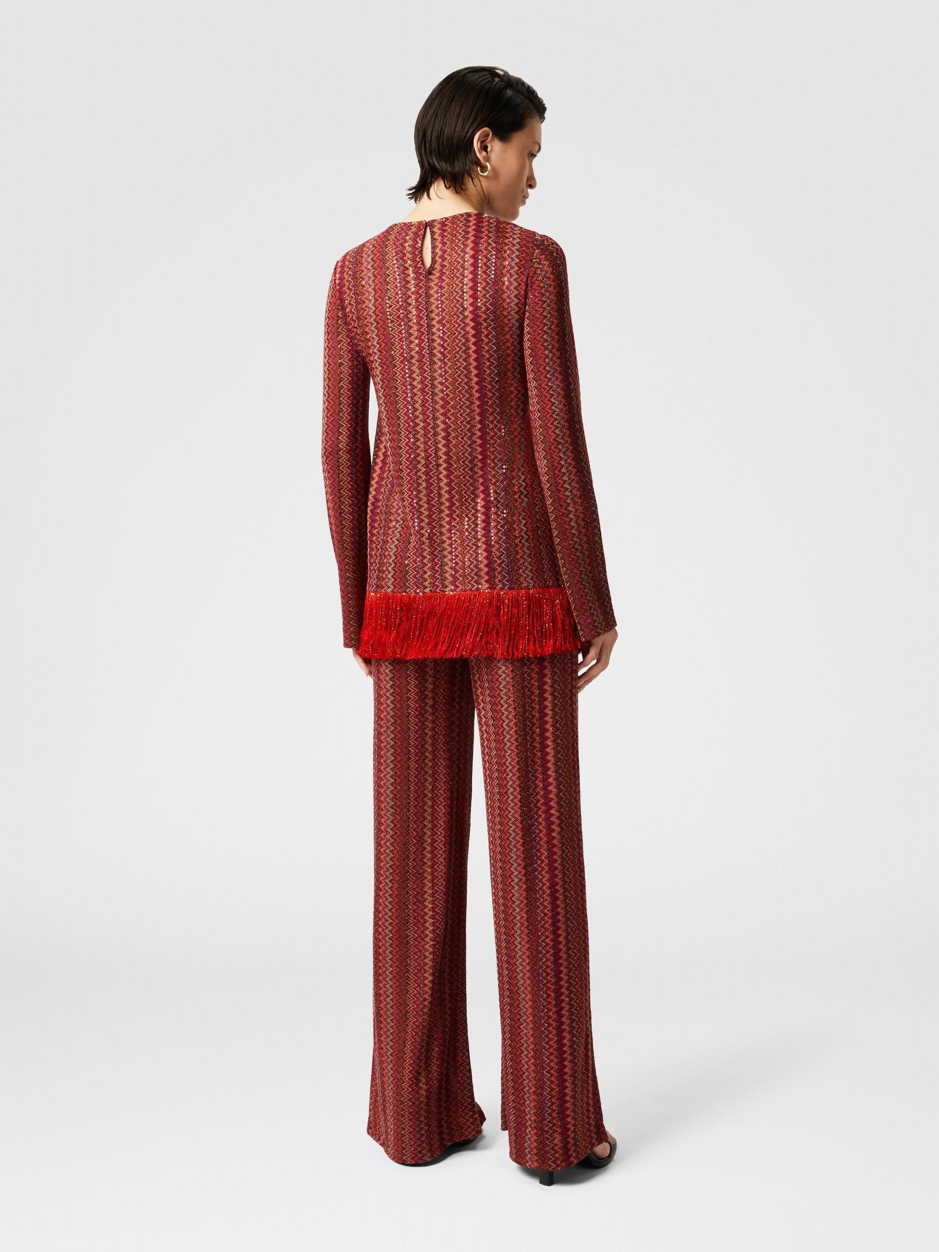 Zig zag sweater with sequins and asymmetrical hem with fringes Product Image