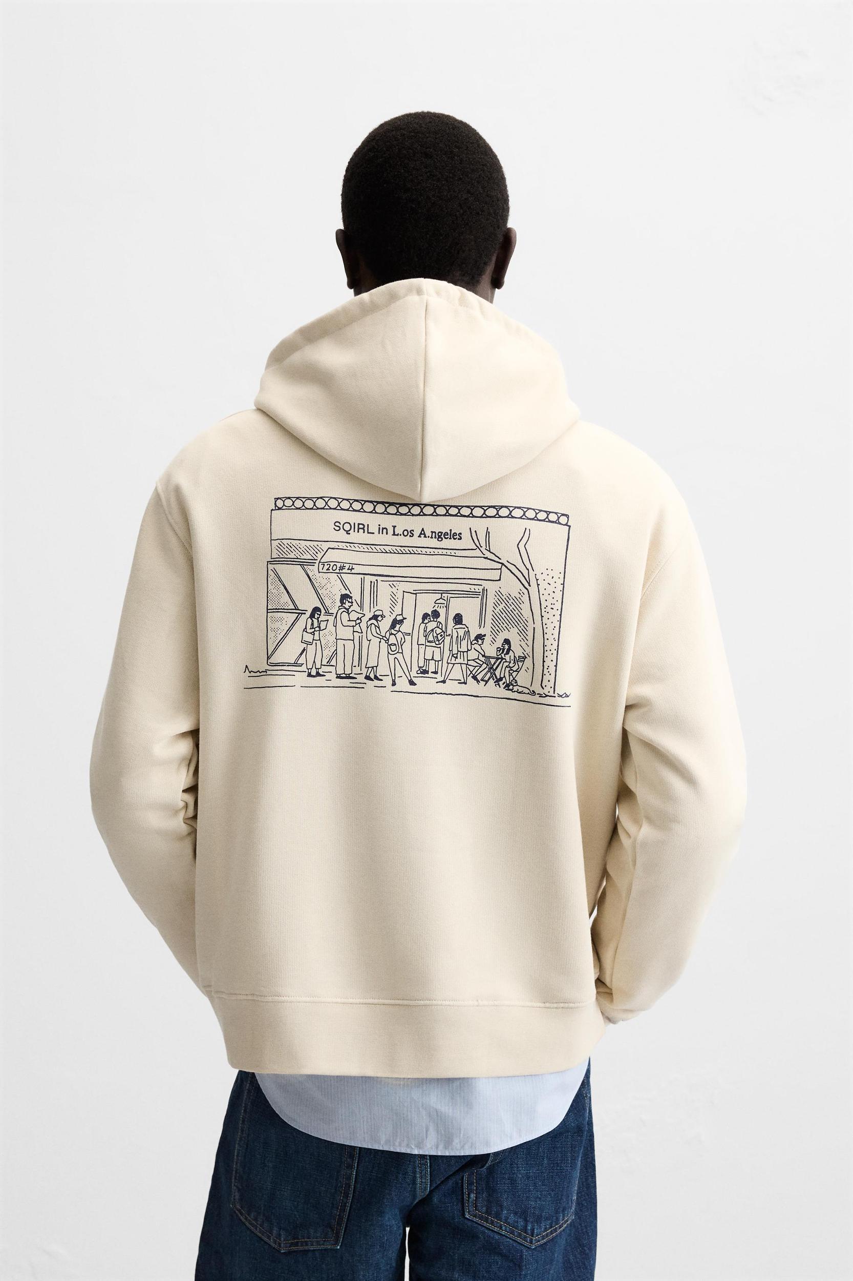 GRAPHIC “SQIRL” HOODIE SWEATSHIRT Product Image