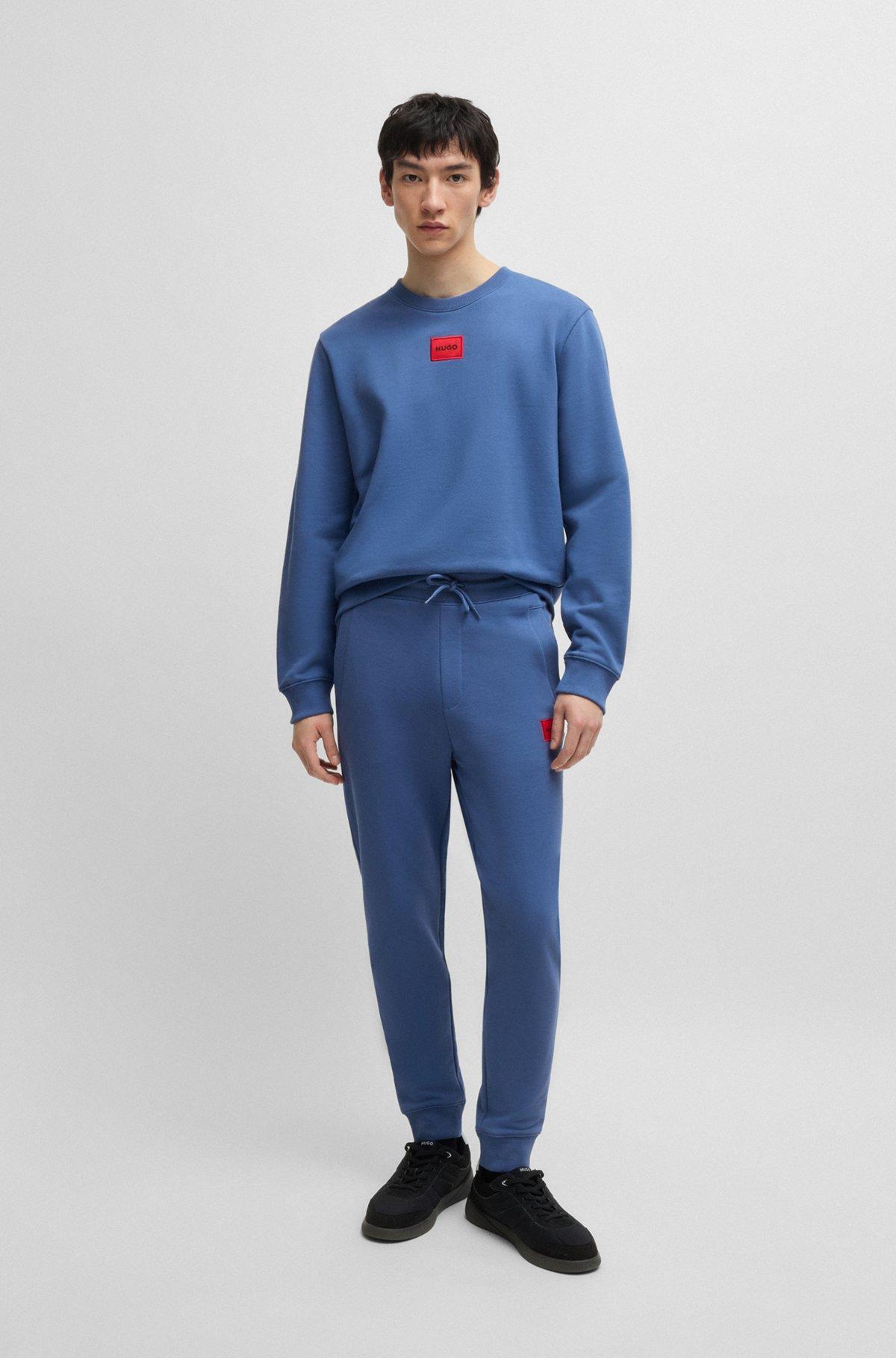Cotton-terry tracksuit bottoms with logo label Product Image