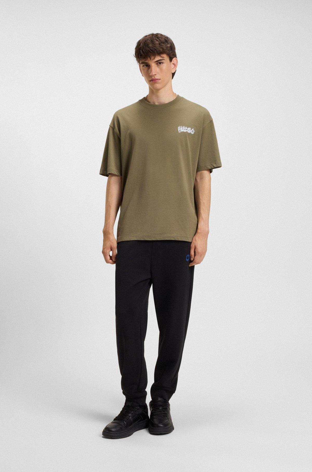 Cotton-terry tracksuit bottoms with Happy HUGO logo Product Image
