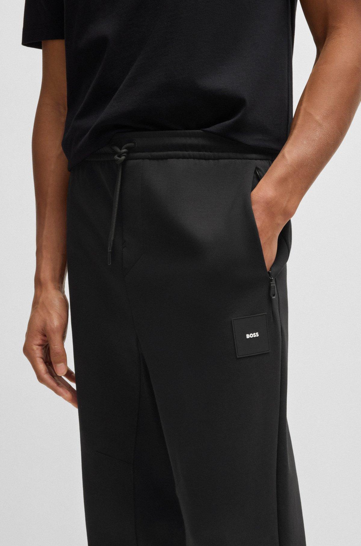 Stretch tracksuit bottoms with logo patch Product Image