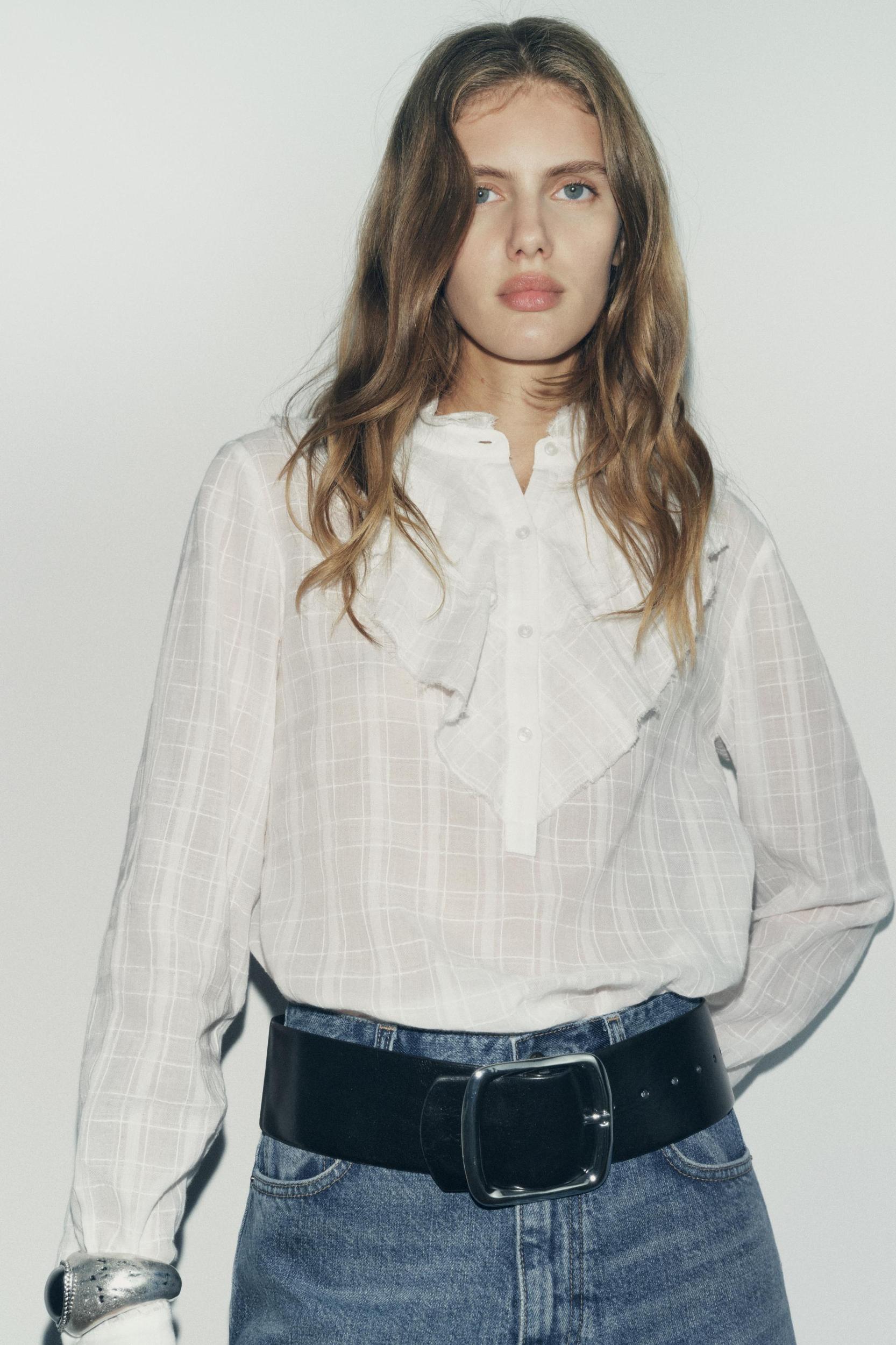 ZARA WOMAN COLLECTION<br/><br/>Blouse made with cotton. Round neck and long sleeves. Self ruffle detail. Front button closure. Product Image