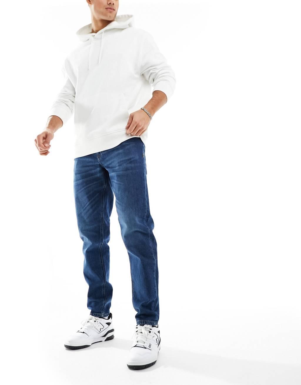 ASOS DESIGN stretch tapered jeans in vintage dark wash Product Image