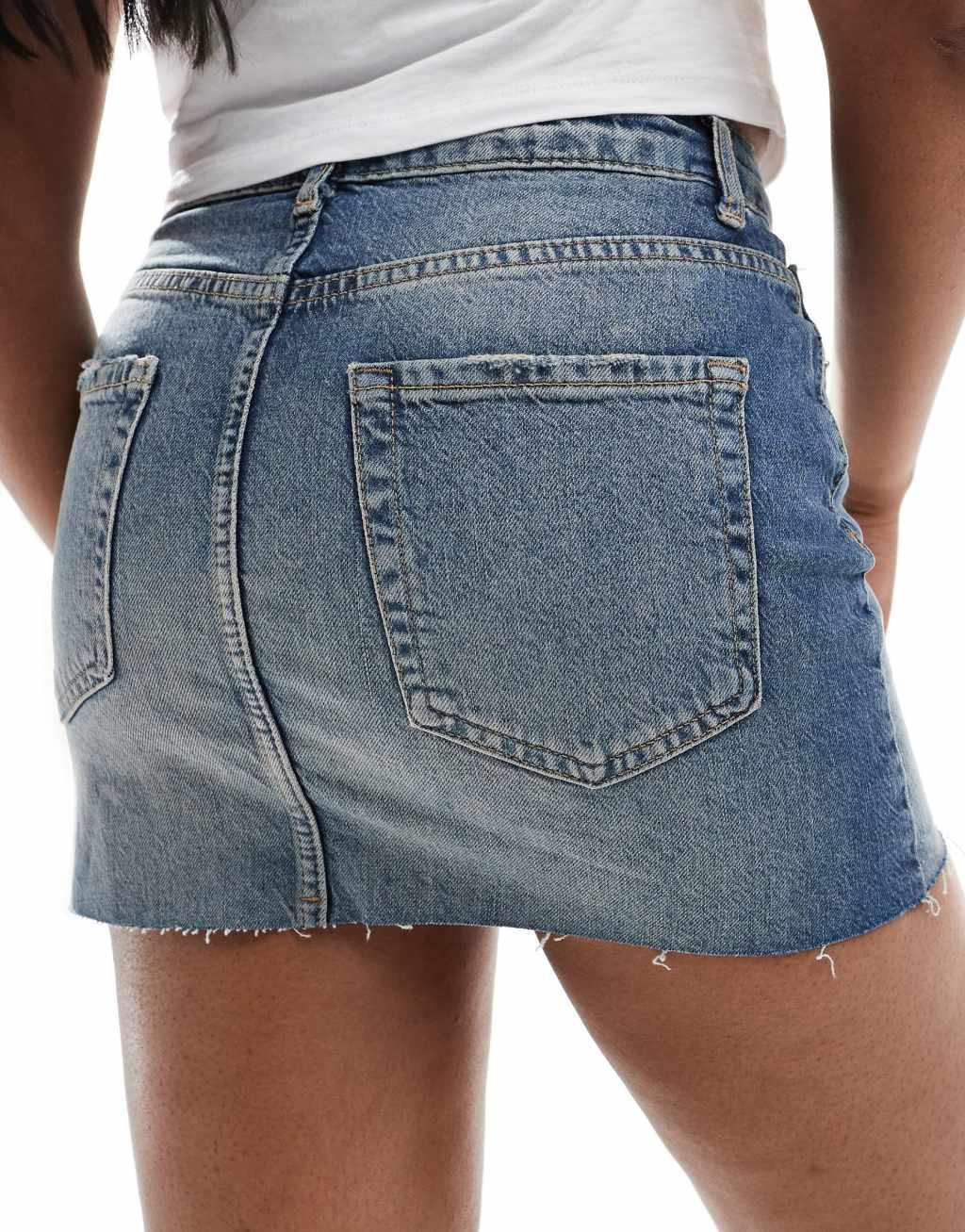 Pull&Bear raw hem denim mini skirt in washed blue Product Image