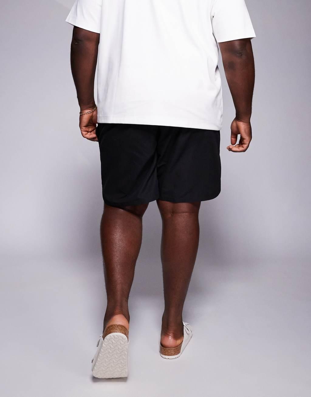 ASOS DESIGN swim shorts in mid length with embroidery placement in black  Product Image