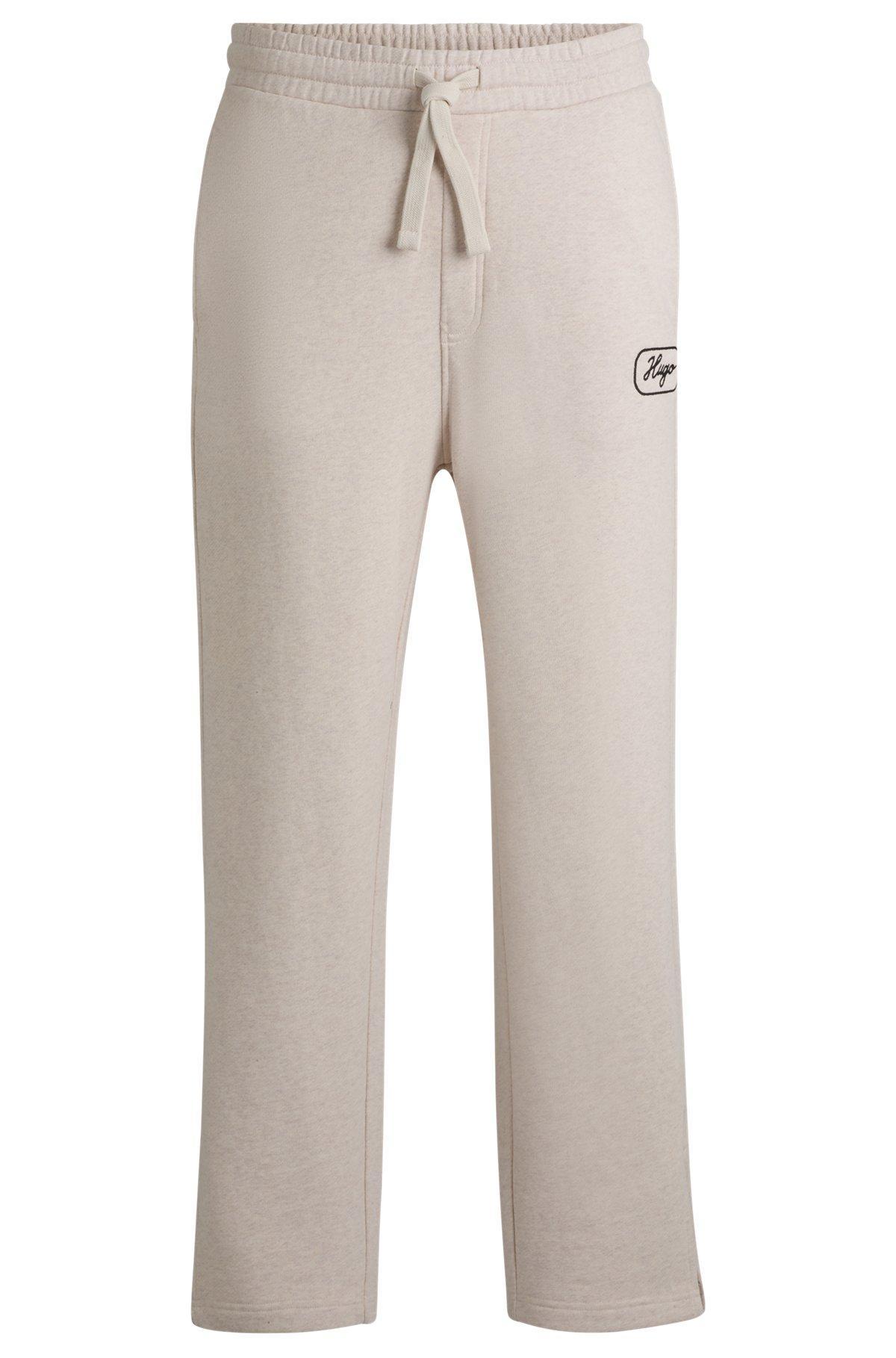 Cotton-terry tracksuit bottoms with embroidered graphics Product Image