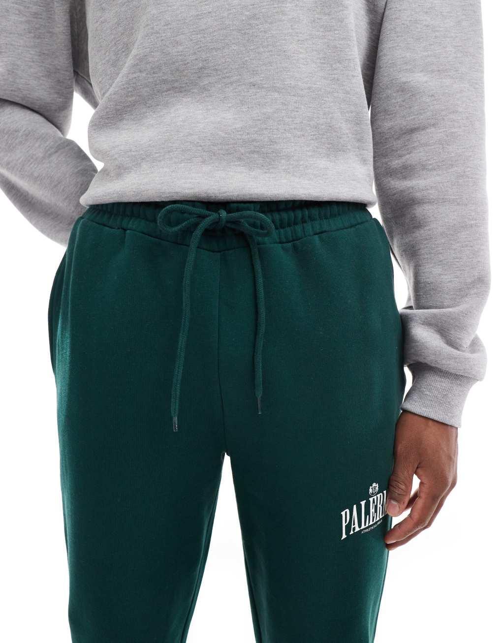 ASOS DESIGN straight leg sweatpants with Palermo print in green Product Image