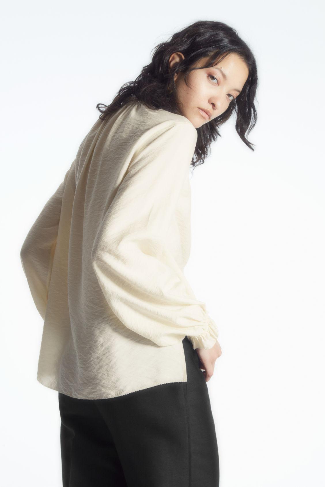 RUFFLED HIGH-NECK BLOUSE Product Image