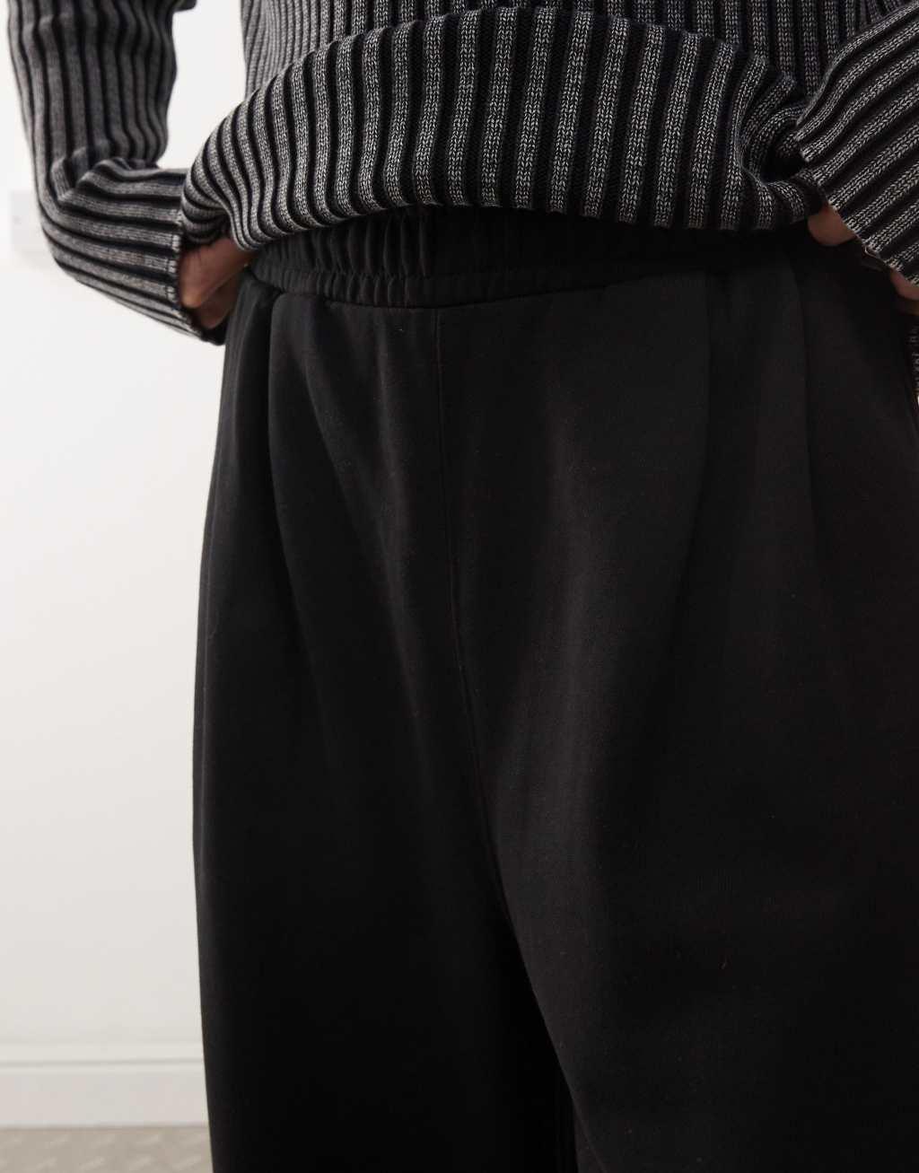 Weekday Wind super wide leg sweatpants with front pleats in black Product Image