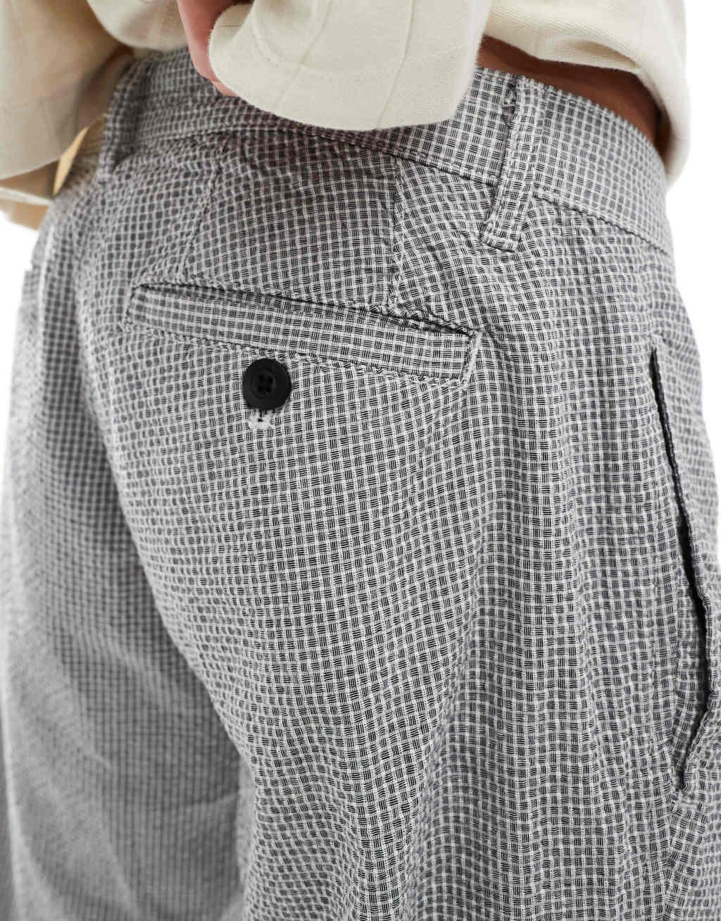ASOS DESIGN tapered pleated pants in black and white textured micro plaid Product Image