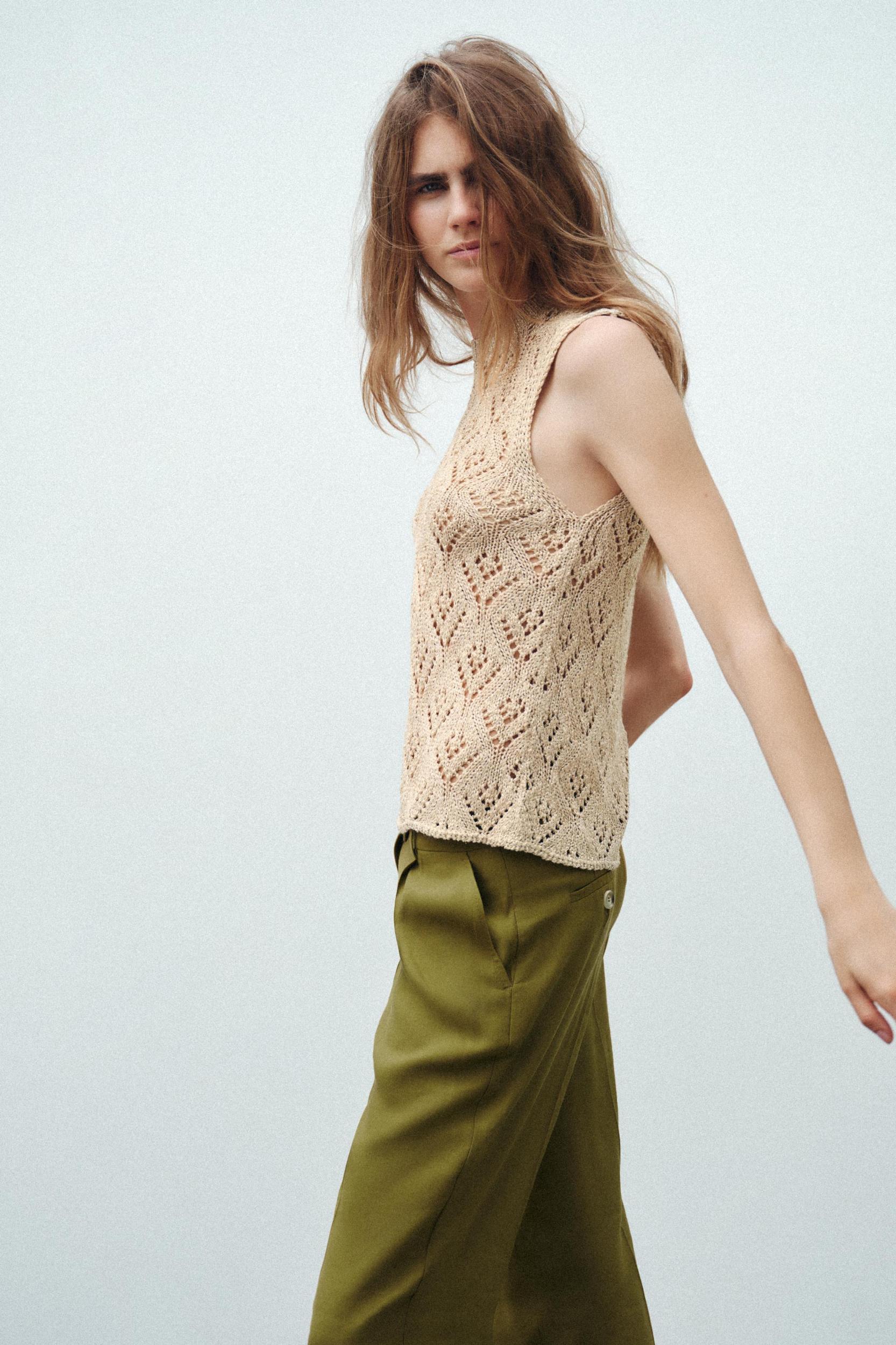 Round neck halter top. Knit fabric with openings and metallic thread. Product Image