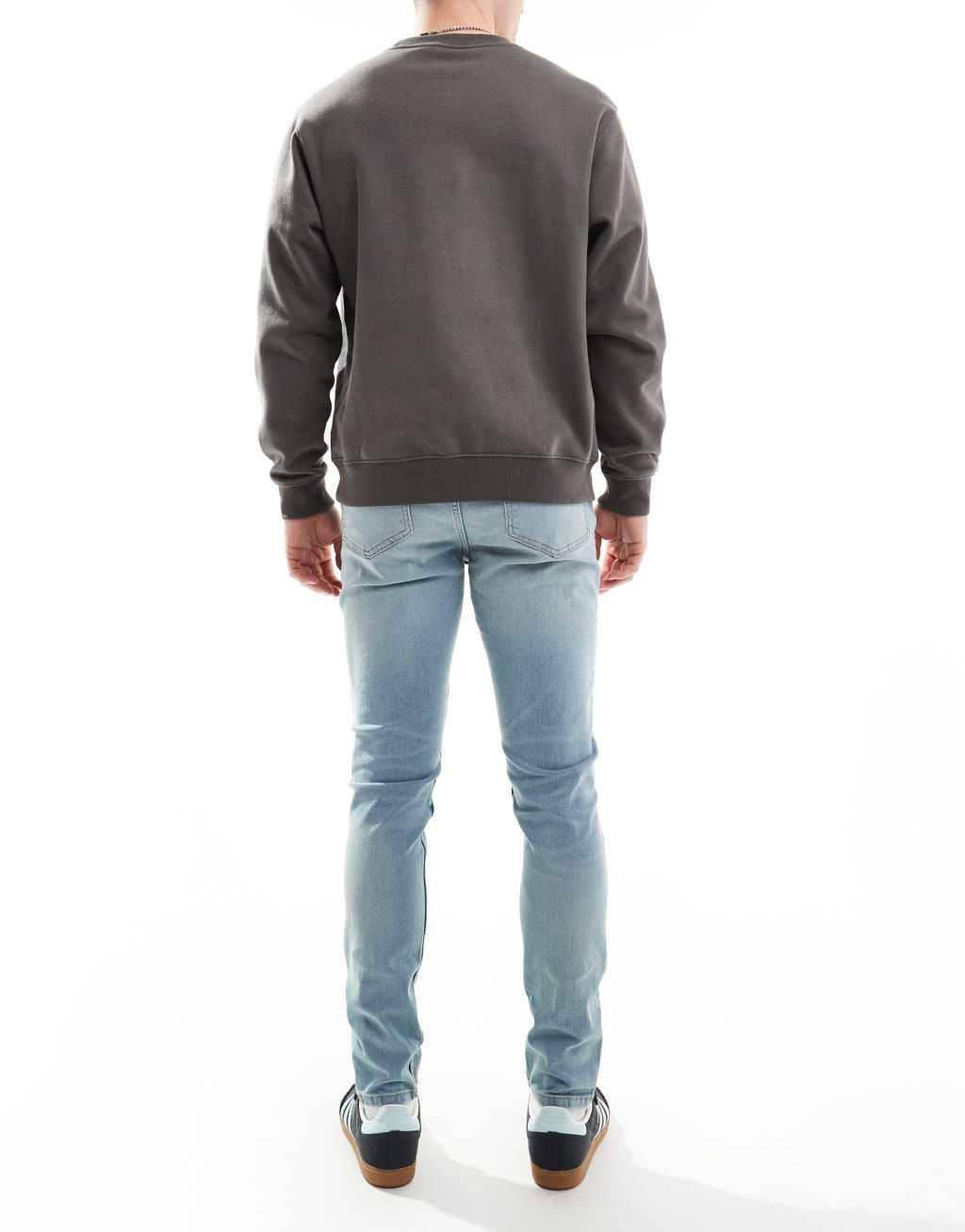 ASOS DESIGN skinny jeans in light wash blue with tint  Product Image