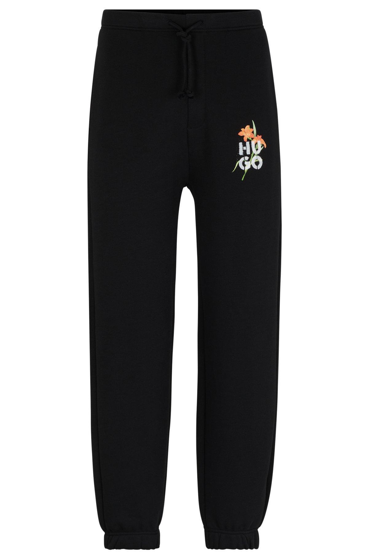 Relaxed-fit tracksuit bottoms with floral logo artwork Product Image