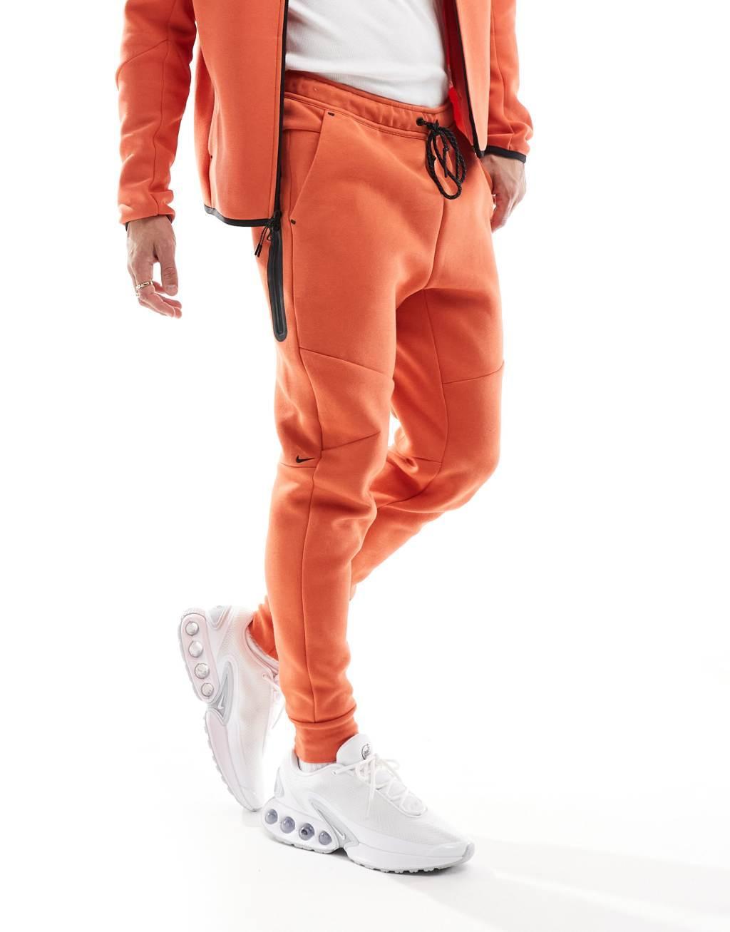 Nike Tech Fleece cuffed sweatpants in orange Product Image