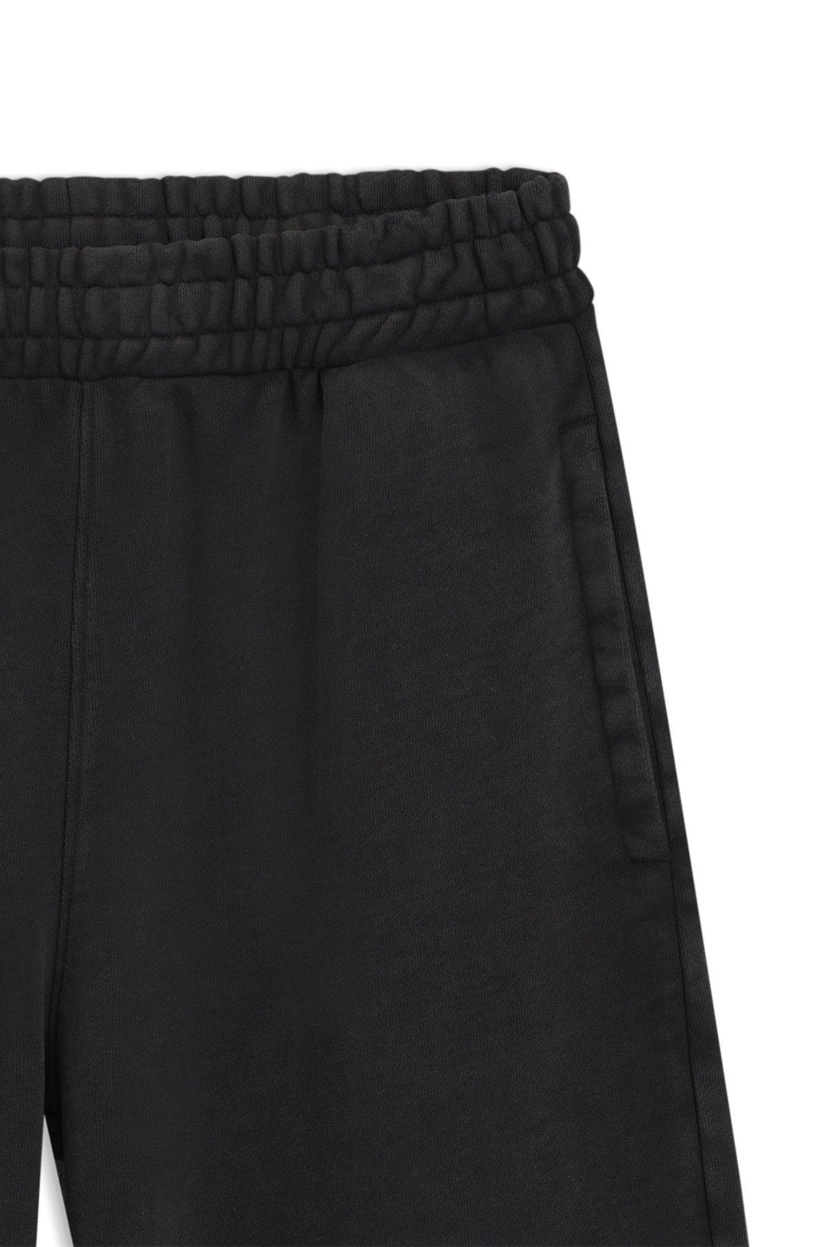 HUGO - Loose-fit tracksuit bottoms in cotton terry - Black Product Image