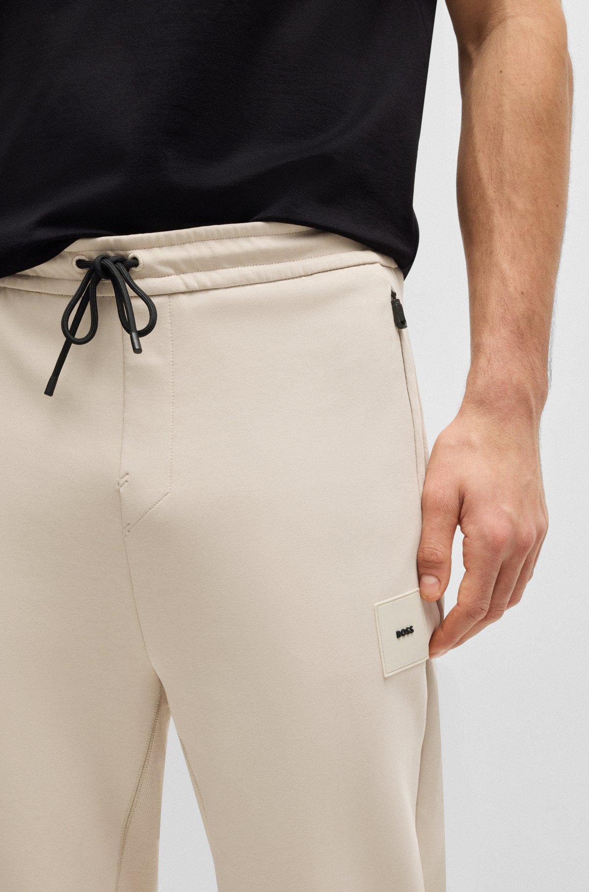 Stretch tracksuit bottoms with logo patch Product Image