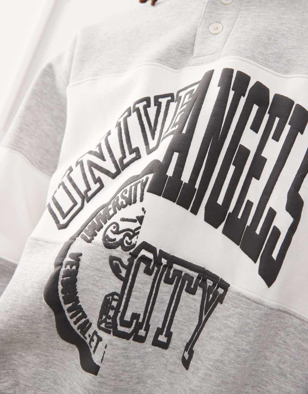 Weekday Andre oversized polo sweatshirt with cut and sew varsity graphic in gray melange Product Image