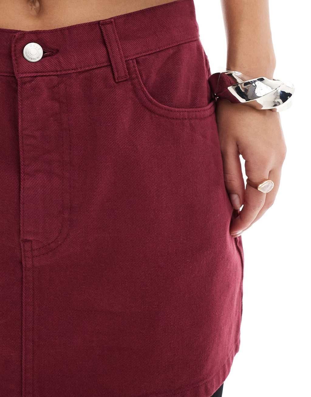ASOS DESIGN denim mini skirt in burgundy Product Image