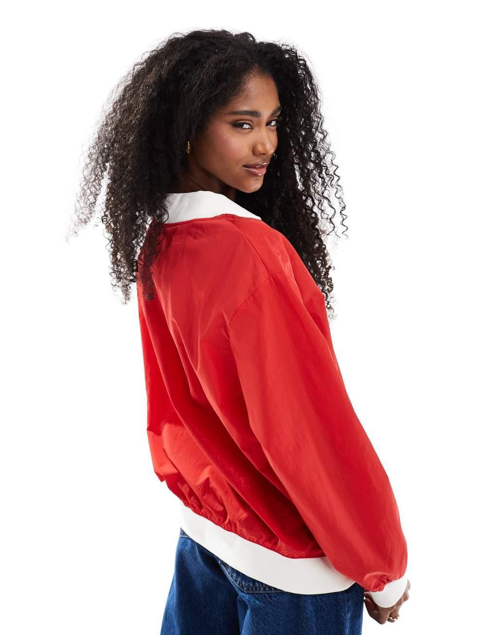 Nike Essential woven v-neck sweatshirt in red Product Image