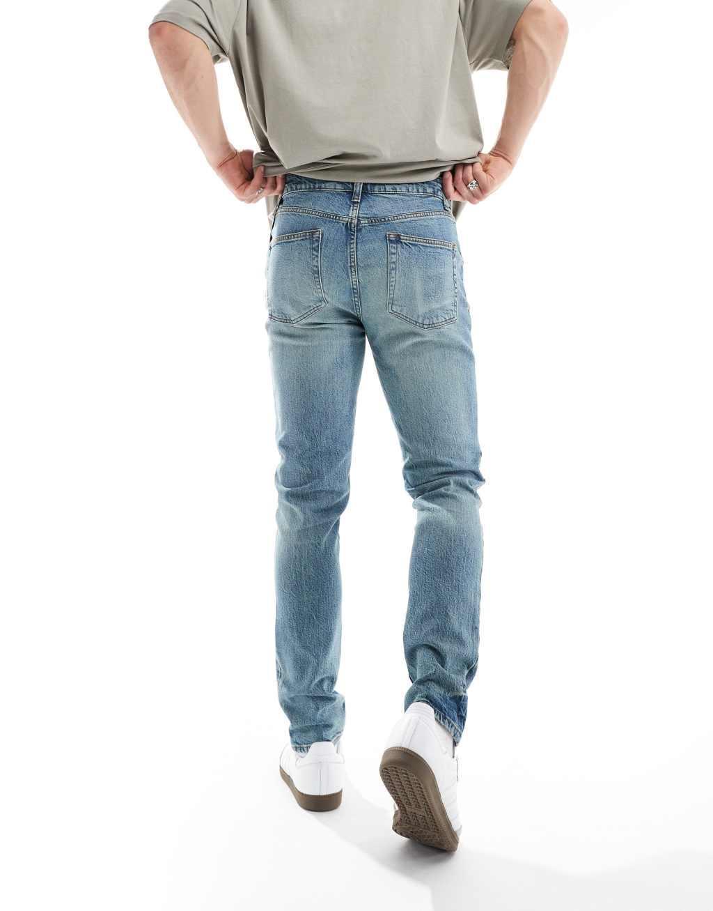 ASOS DESIGN skinny jeans in a tinted vintage mid wash Product Image