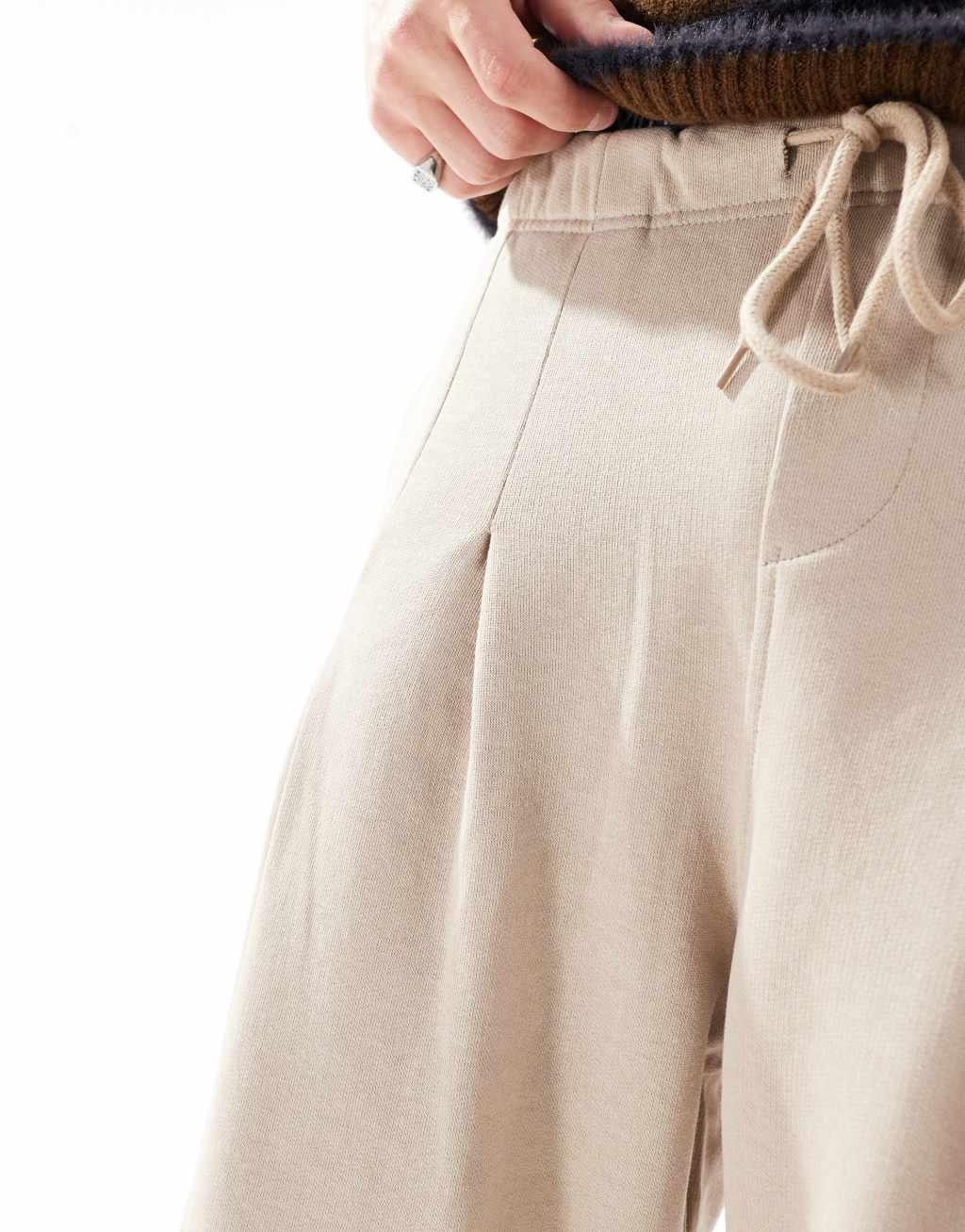 ASOS DESIGN wide leg pleated sweatpants in beige Product Image