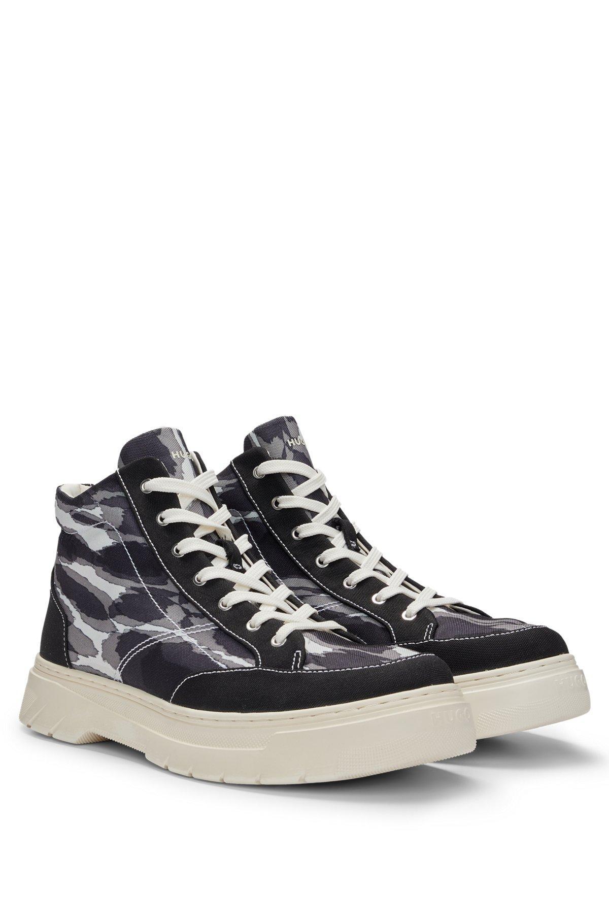 Camouflage-print high-top trainers with stacked logo Product Image