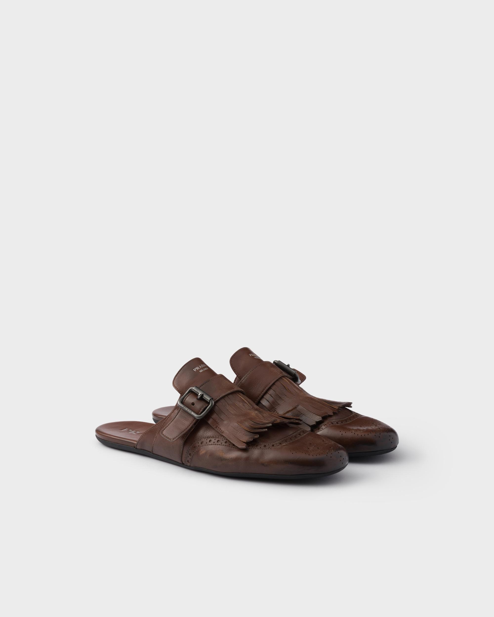 Shuffle antiqued leather mules with buckled strap and fringe Product Image