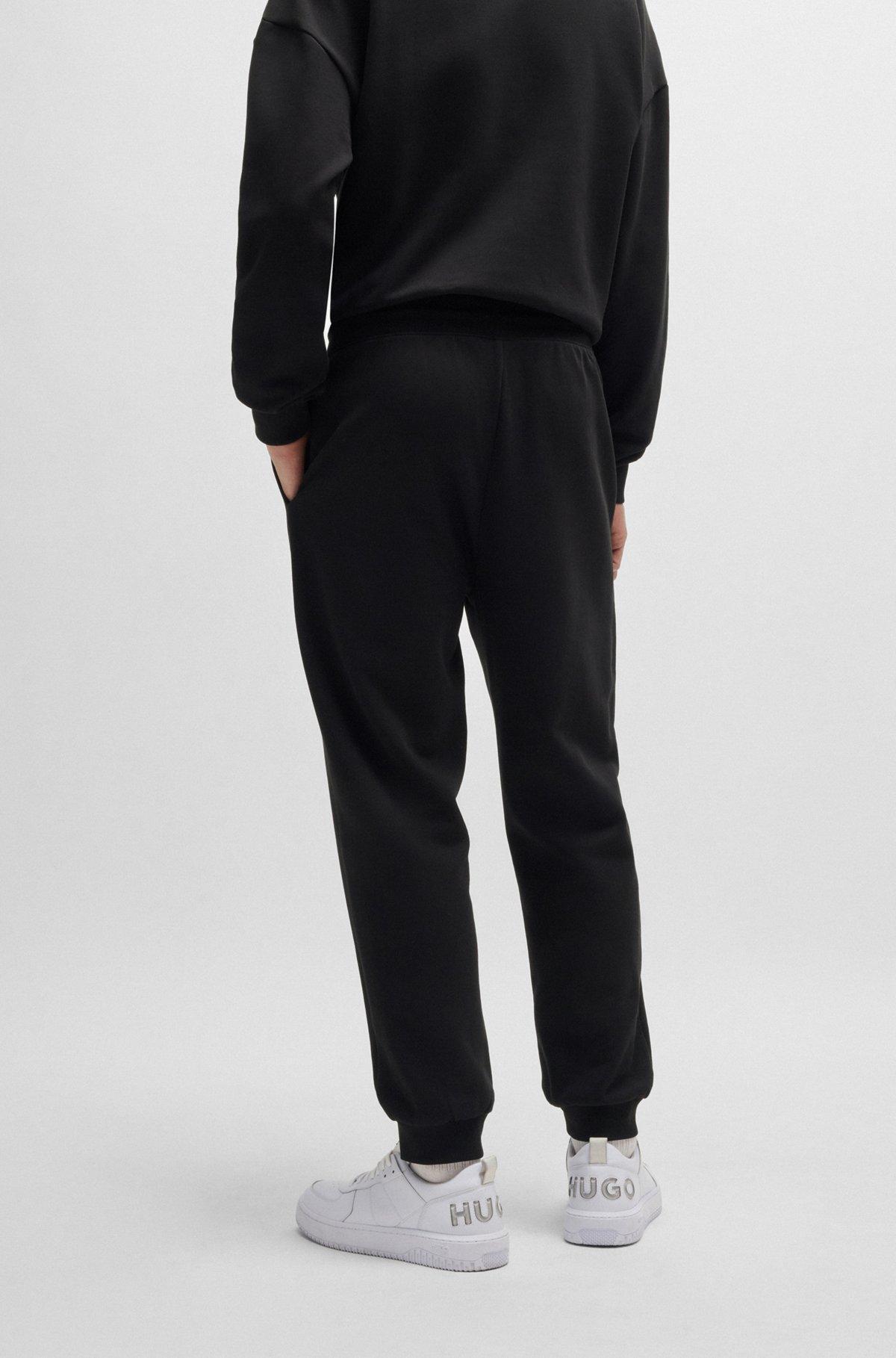 Cotton-terry tracksuit bottoms with Happy HUGO logo Product Image